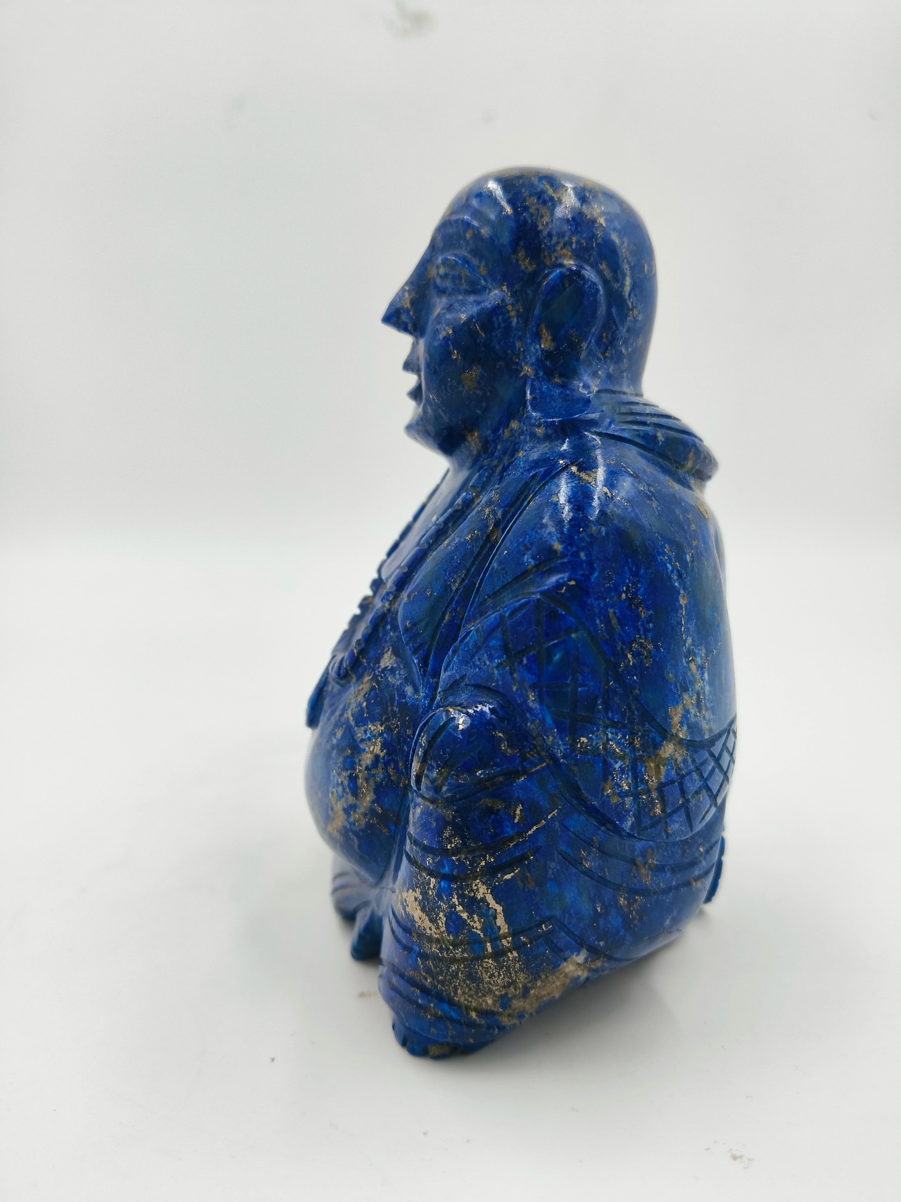 Side view of a blue lapis laughing Buddha figurine sculpture
