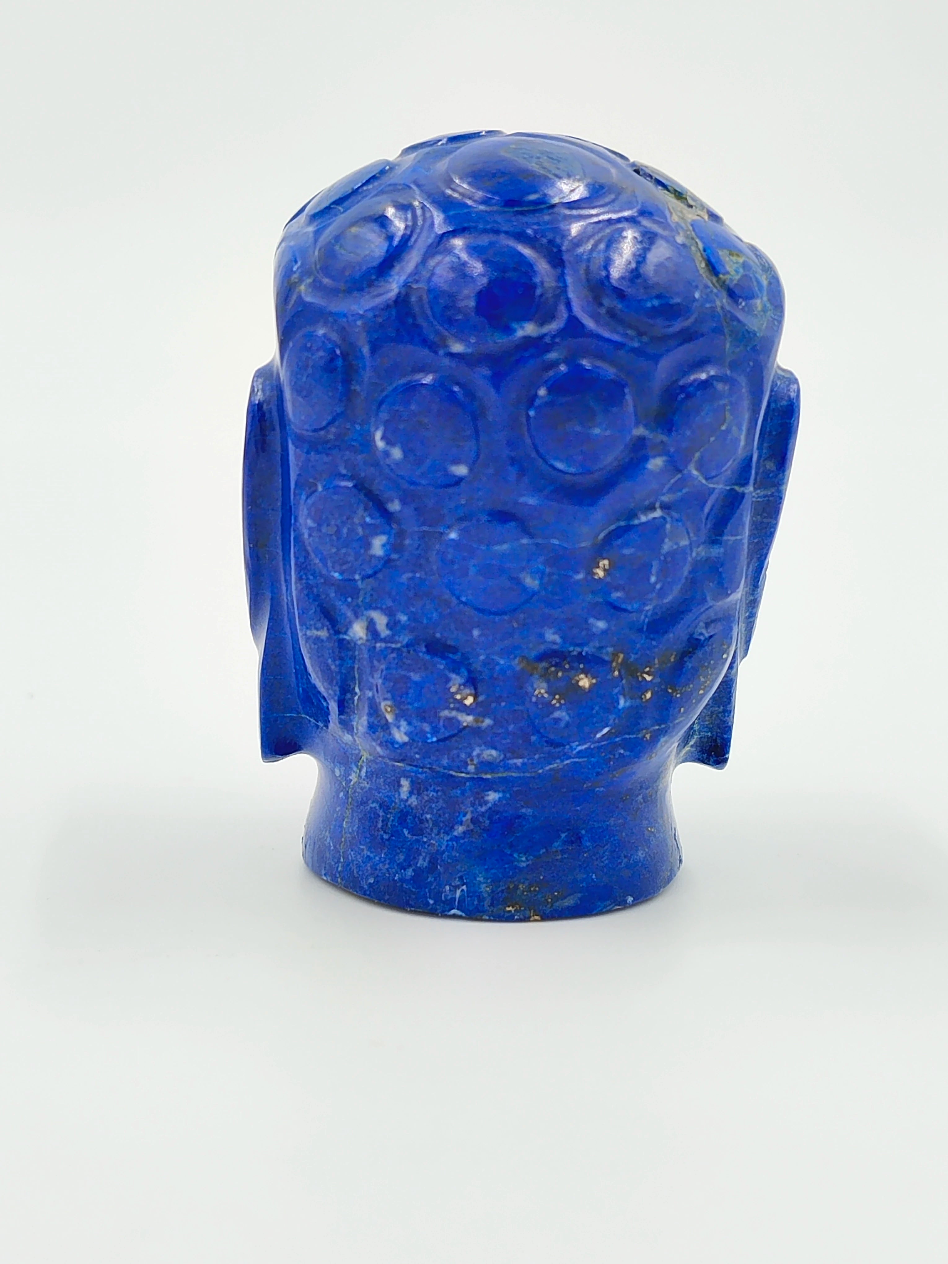 Back view of a small blue lapis lazuli Buddha head sculpture