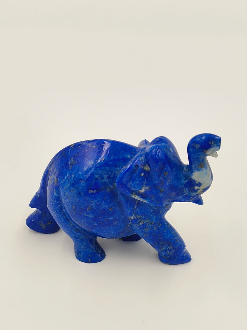small tabletop lapis blue elephant sculpture with trunk raised
