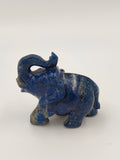 Small blue lapis lazuli elephant figurine with raised trunk side view