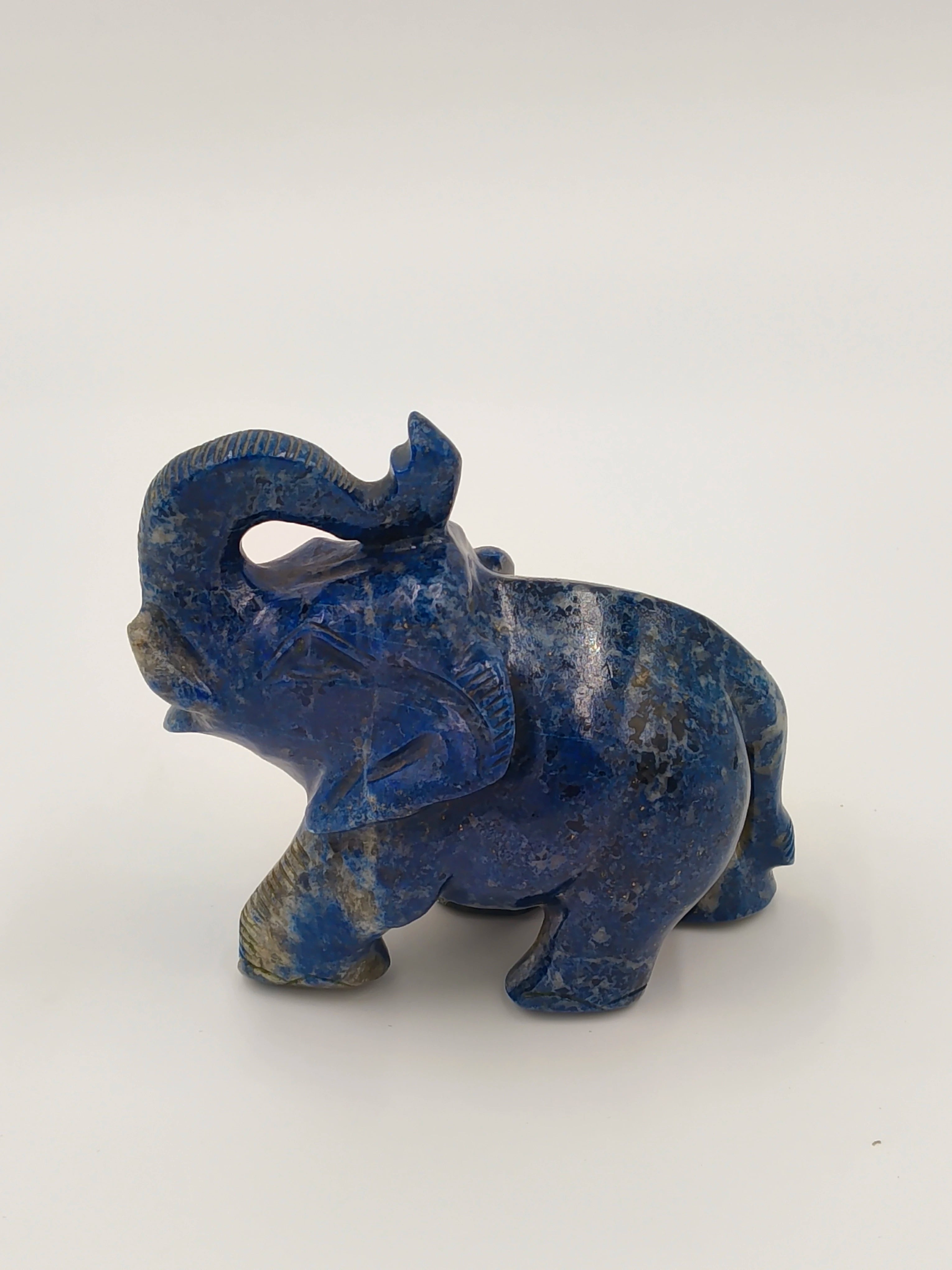 Small blue lapis lazuli elephant figurine with raised trunk side view