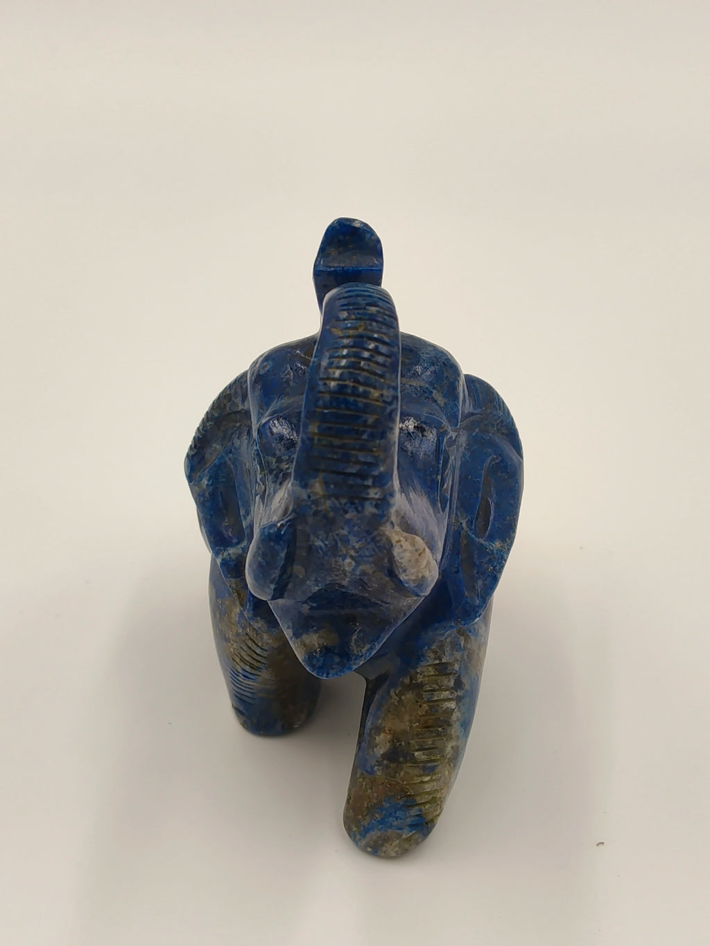 Front view of small blue lapis elephant figurine sculpture
