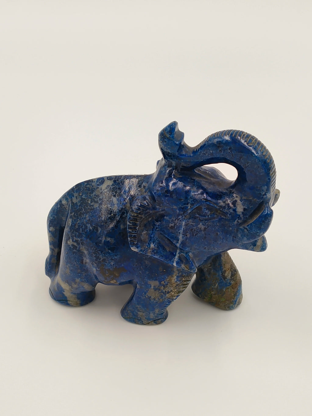 Small blue lapis lazuli elephant figurine sculpture with trunk raised