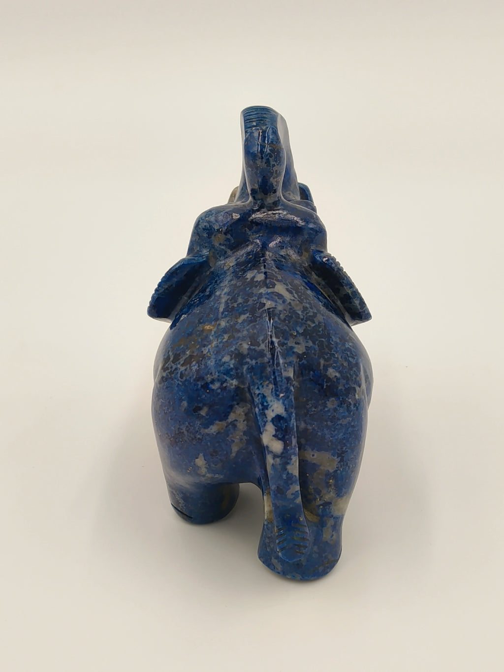 Rear view of small blue lapis elephant figurine sculpture