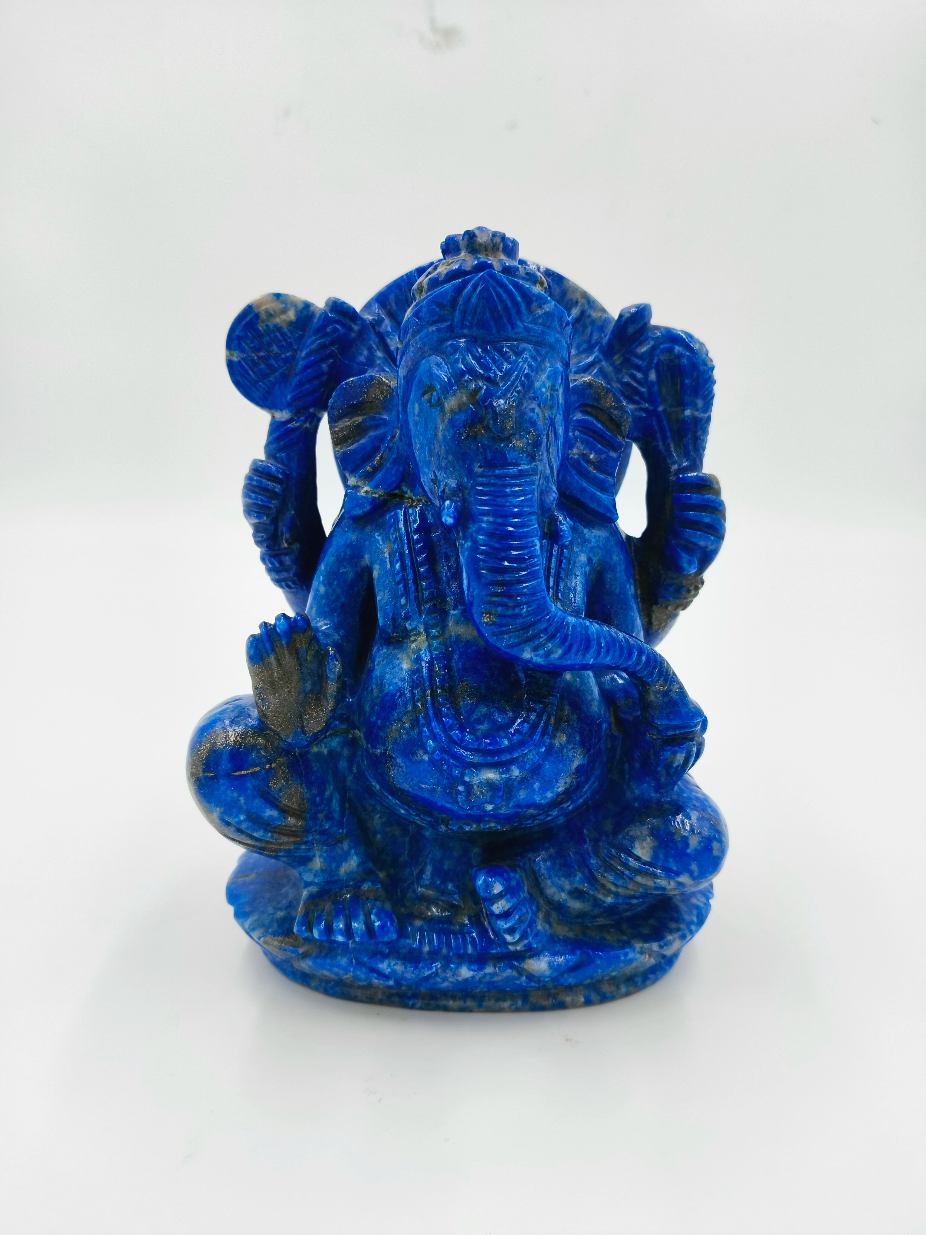 Blue lapis lazuli Ganesh statue sitting with four arms and intricate detailing