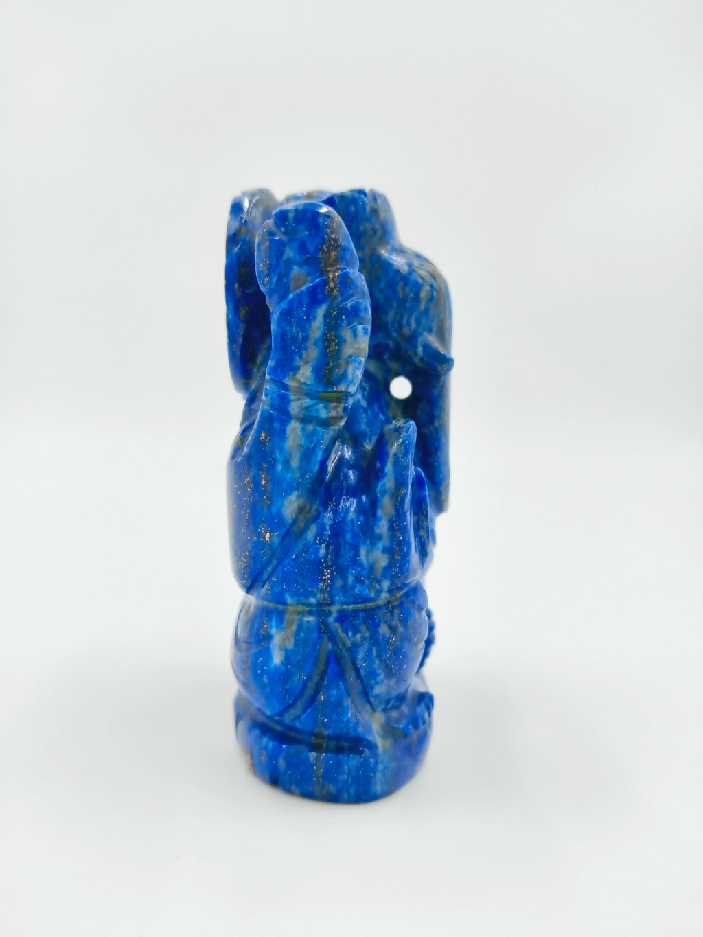 Side view of small blue lapis sculpture of Hindu deity Ganesh