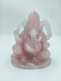 Large rose quartz sculpture of the Hindu deity Ganesh sitting cross-legged