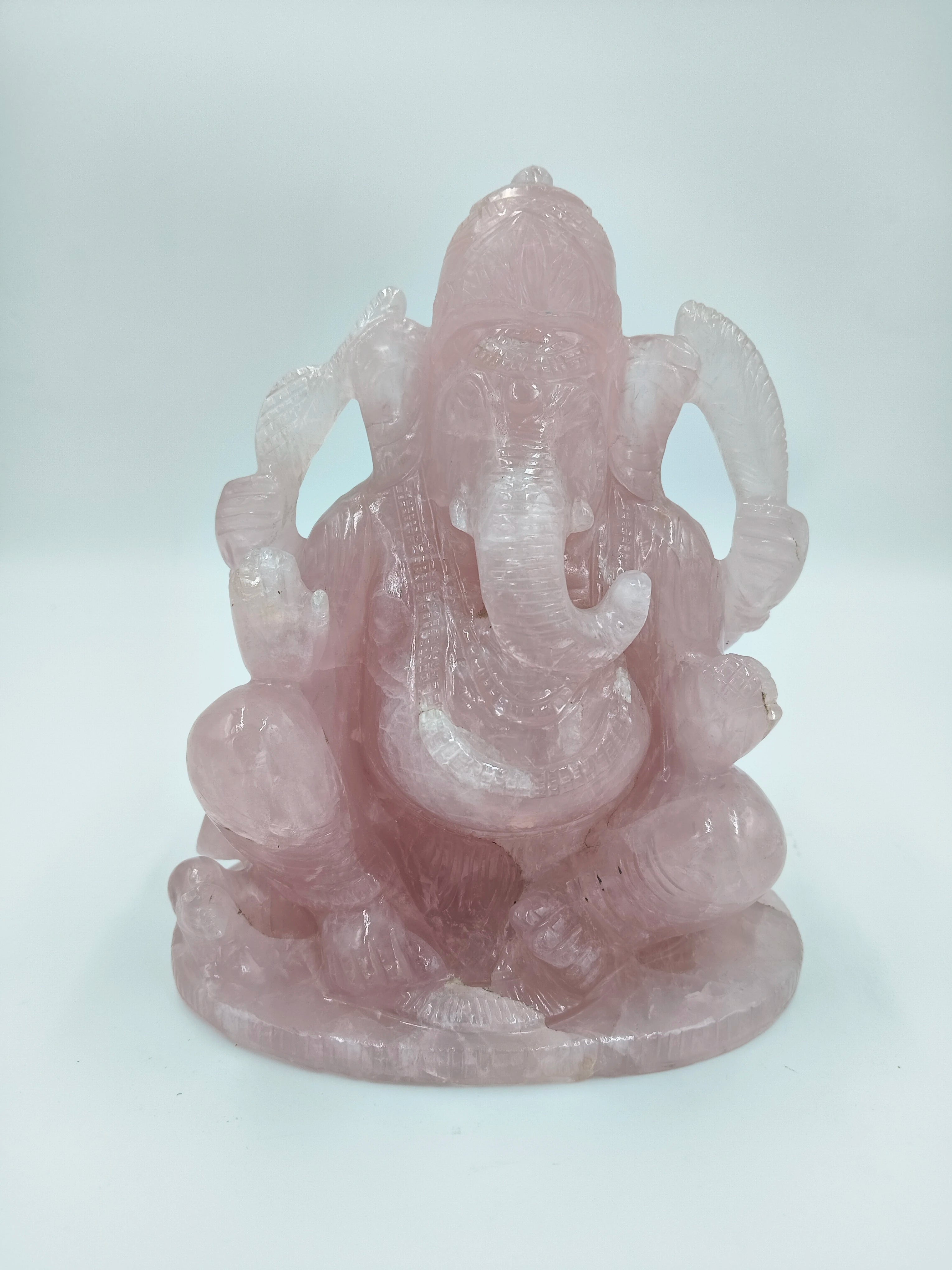 Large rose quartz sculpture of the Hindu deity Ganesh sitting cross-legged