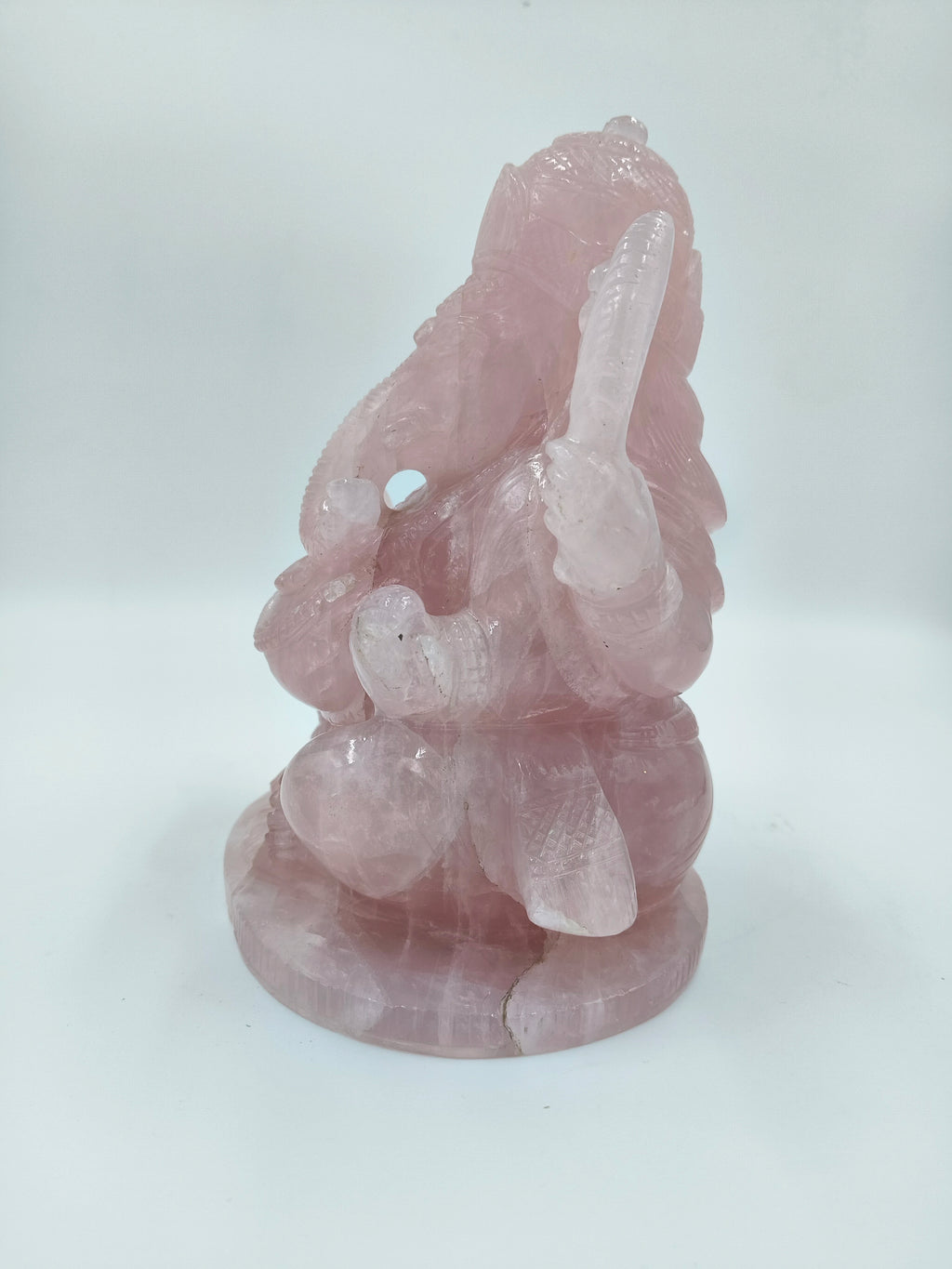 Back view of large rose quartz sculpture of Ganesh deity sitting
