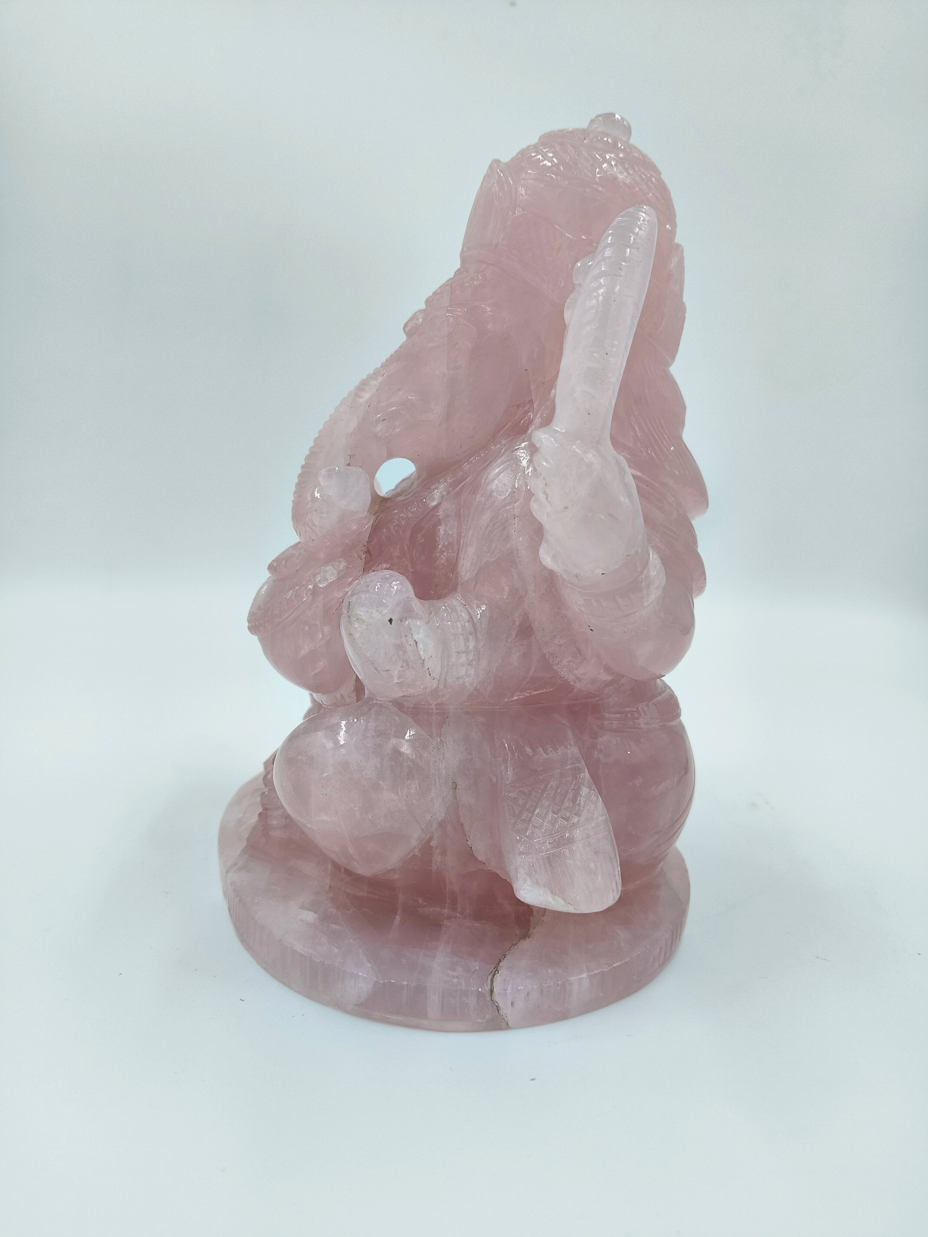 Back view of large rose quartz sculpture of Ganesh deity sitting