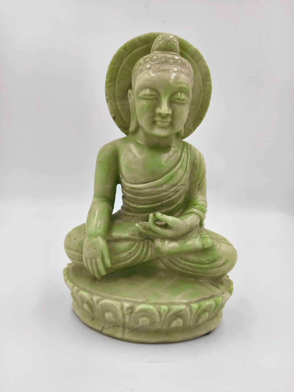 Green serpentine stone Buddha sculpture seated in meditation pose
