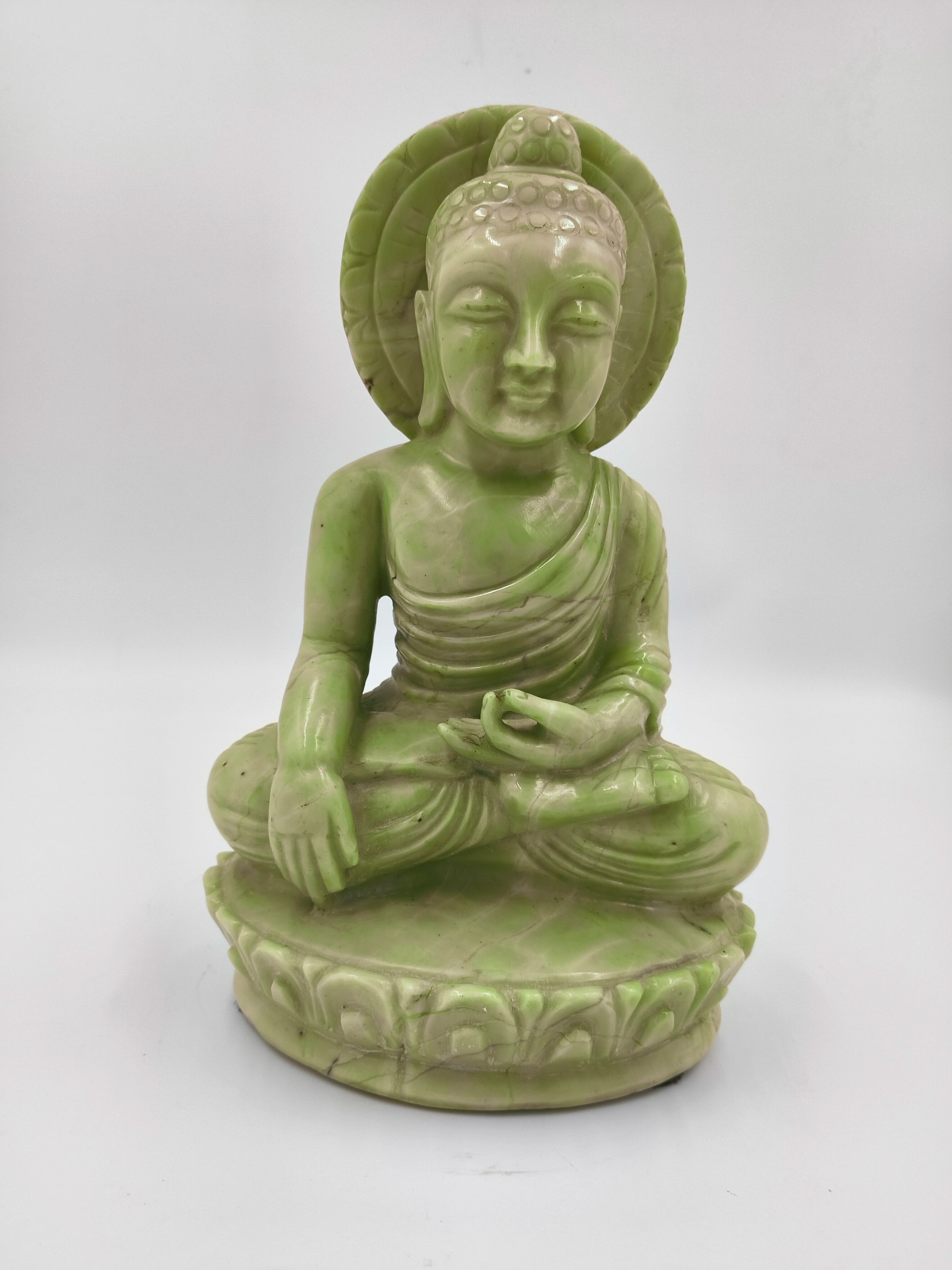 Green serpentine stone Buddha sculpture seated in meditation pose