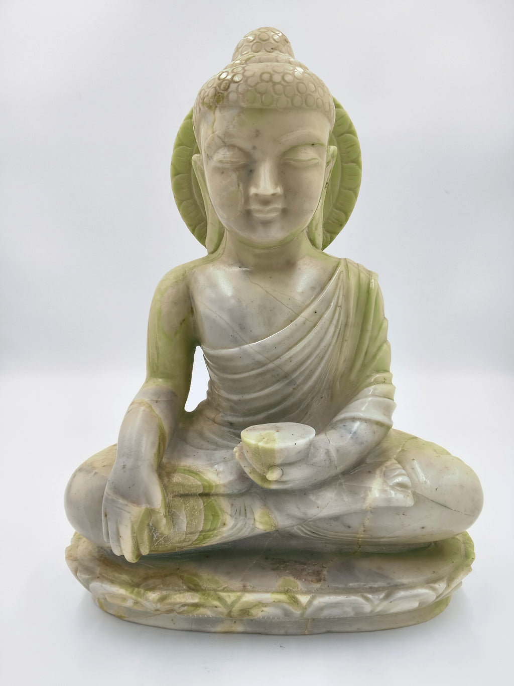 Front view of serpentine stone Buddha statue seated in meditation pose