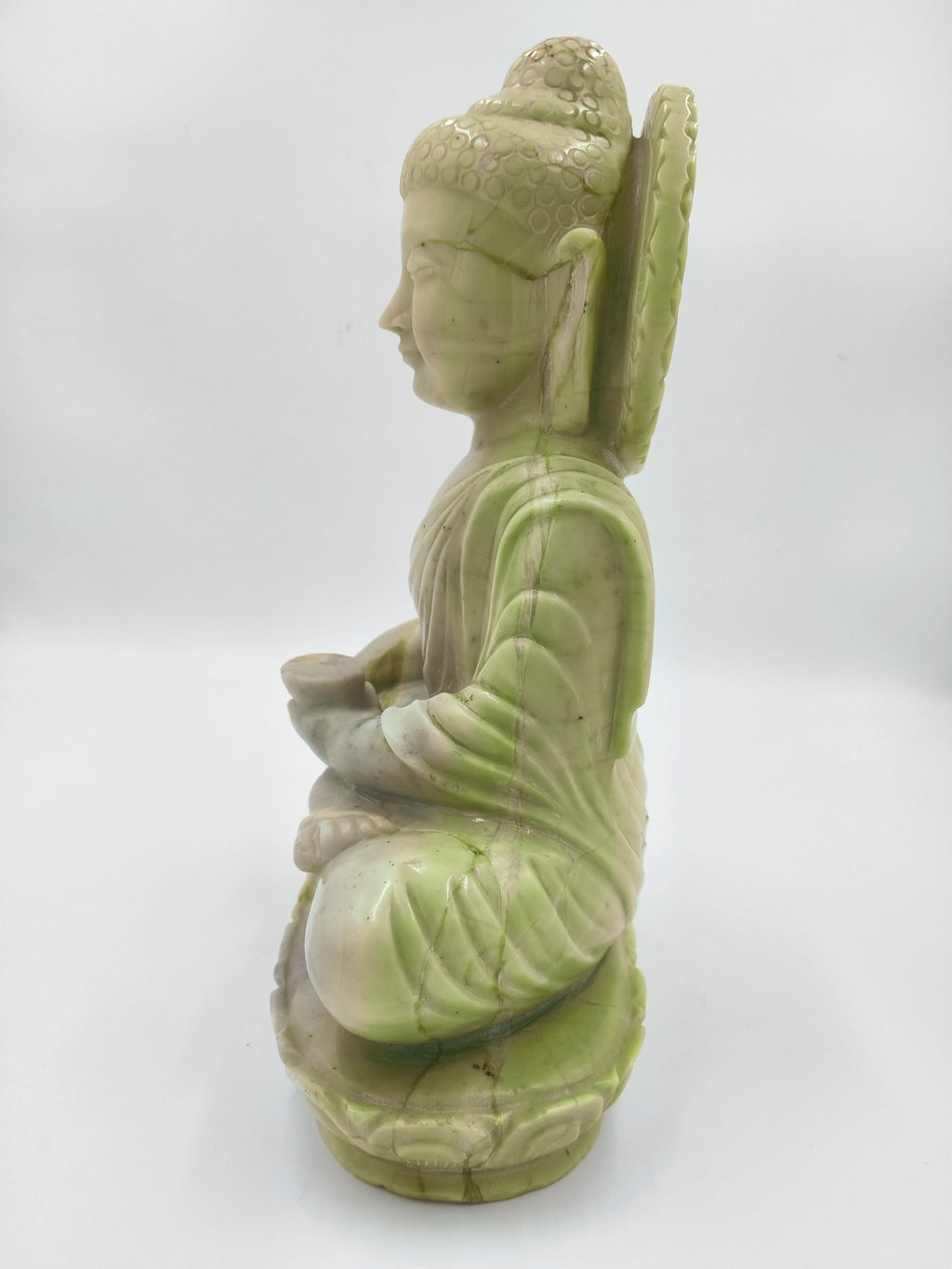 Side view of 10.2 inch serpentine Buddha sculpture seated in meditation pose