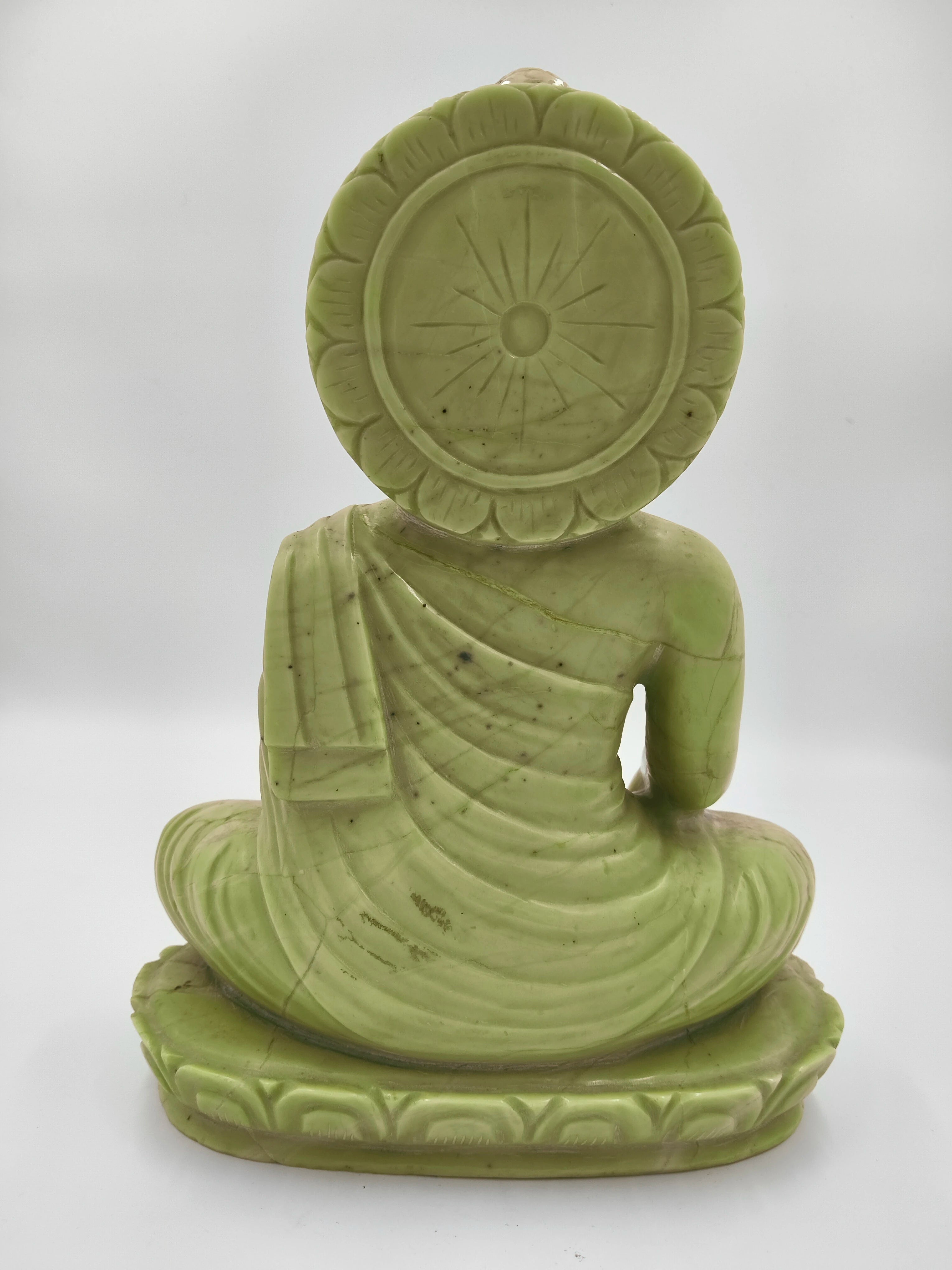 Back view of large green serpentine Buddha sculpture seated on lotus base