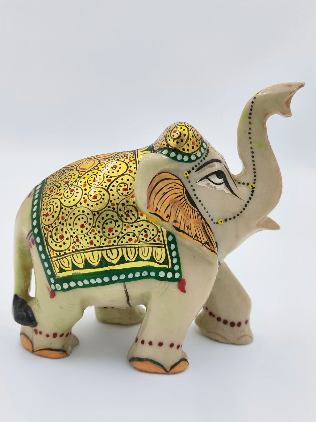 Hand-painted serpentine elephant figurine with ornate golden and green detailing