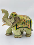 Hand-painted serpentine elephant sculpture with intricate floral patterns and raised trunk
