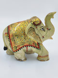 Small serpentine elephant figurine with intricate gold and multicolor detailing