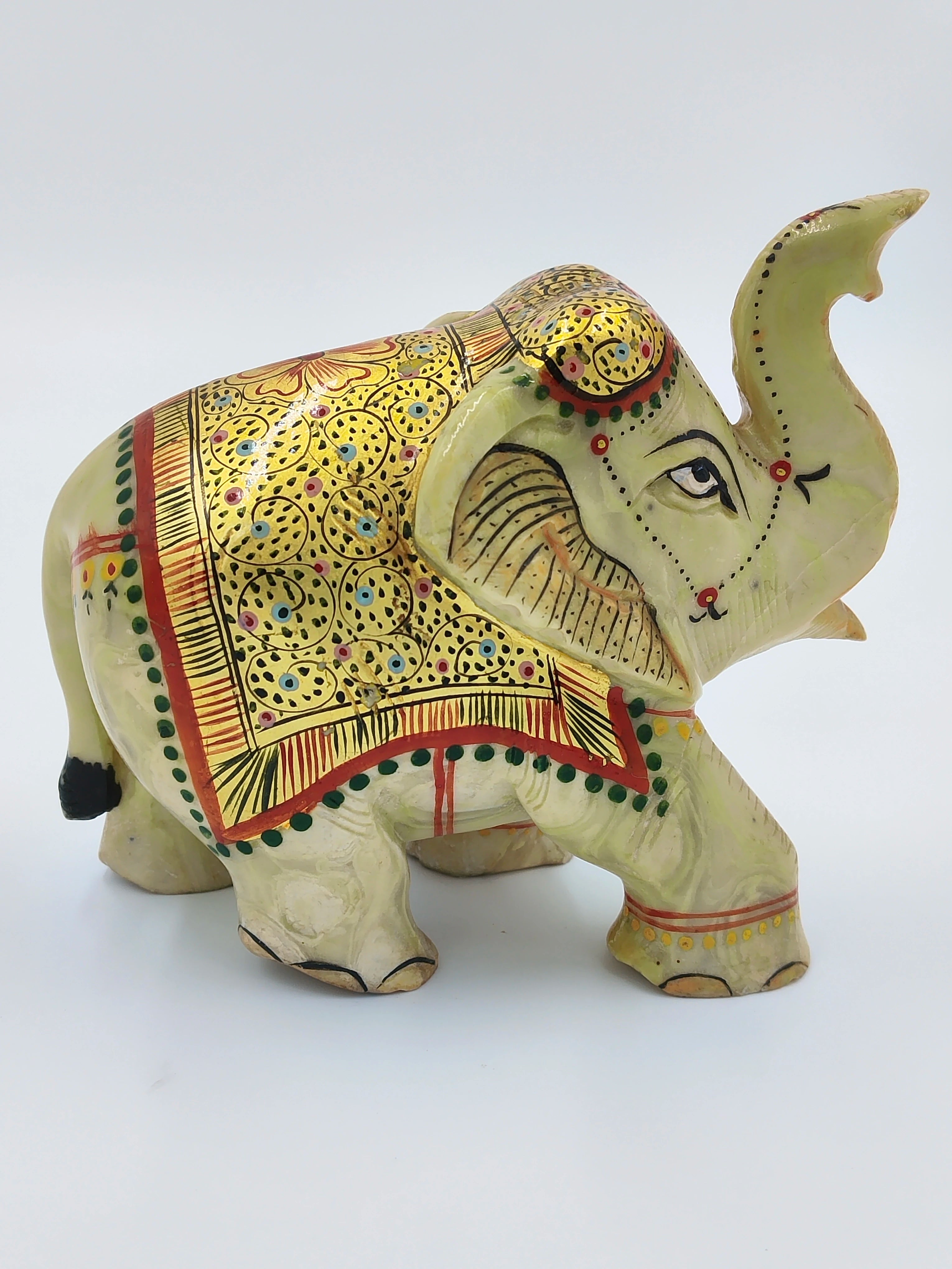 Small serpentine elephant figurine with intricate gold and multicolor detailing
