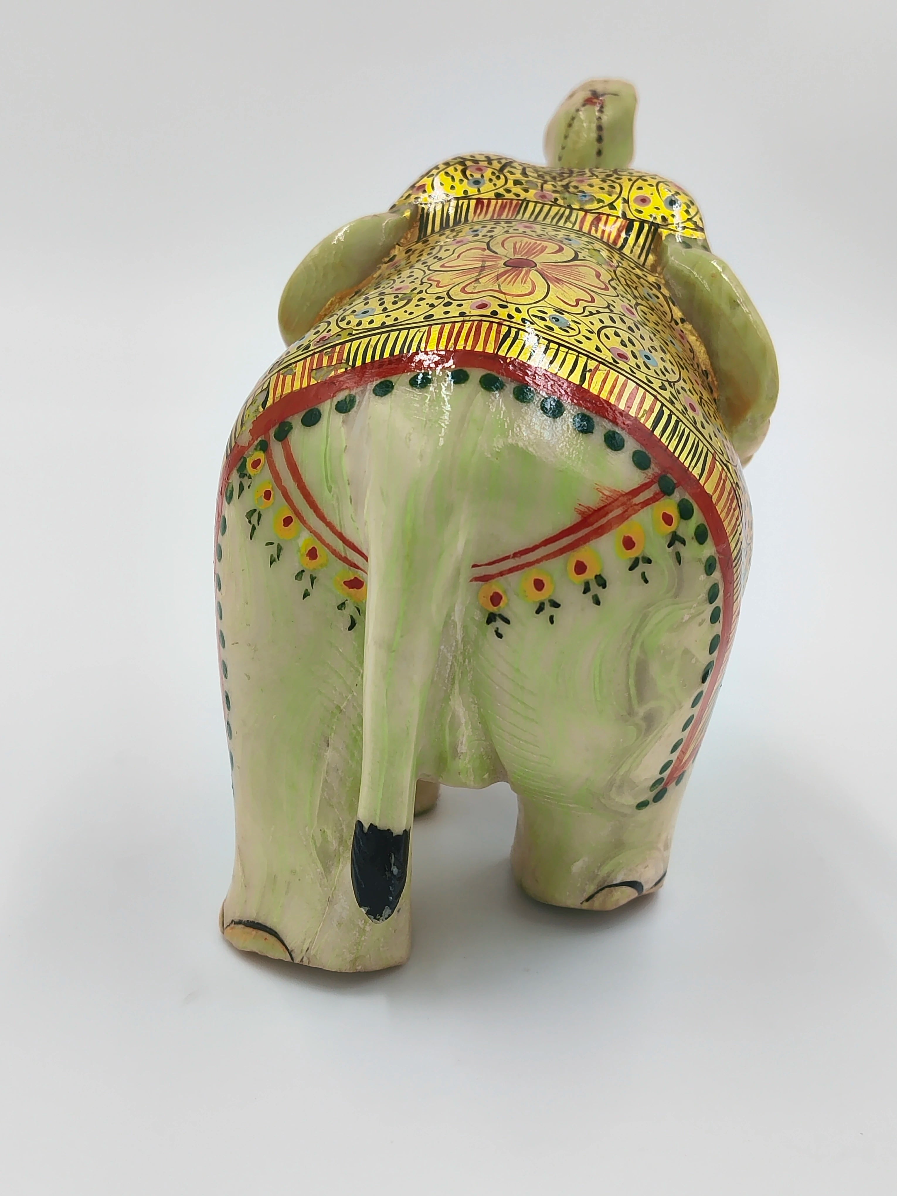 Back view of small serpentine elephant sculpture with decorative paint