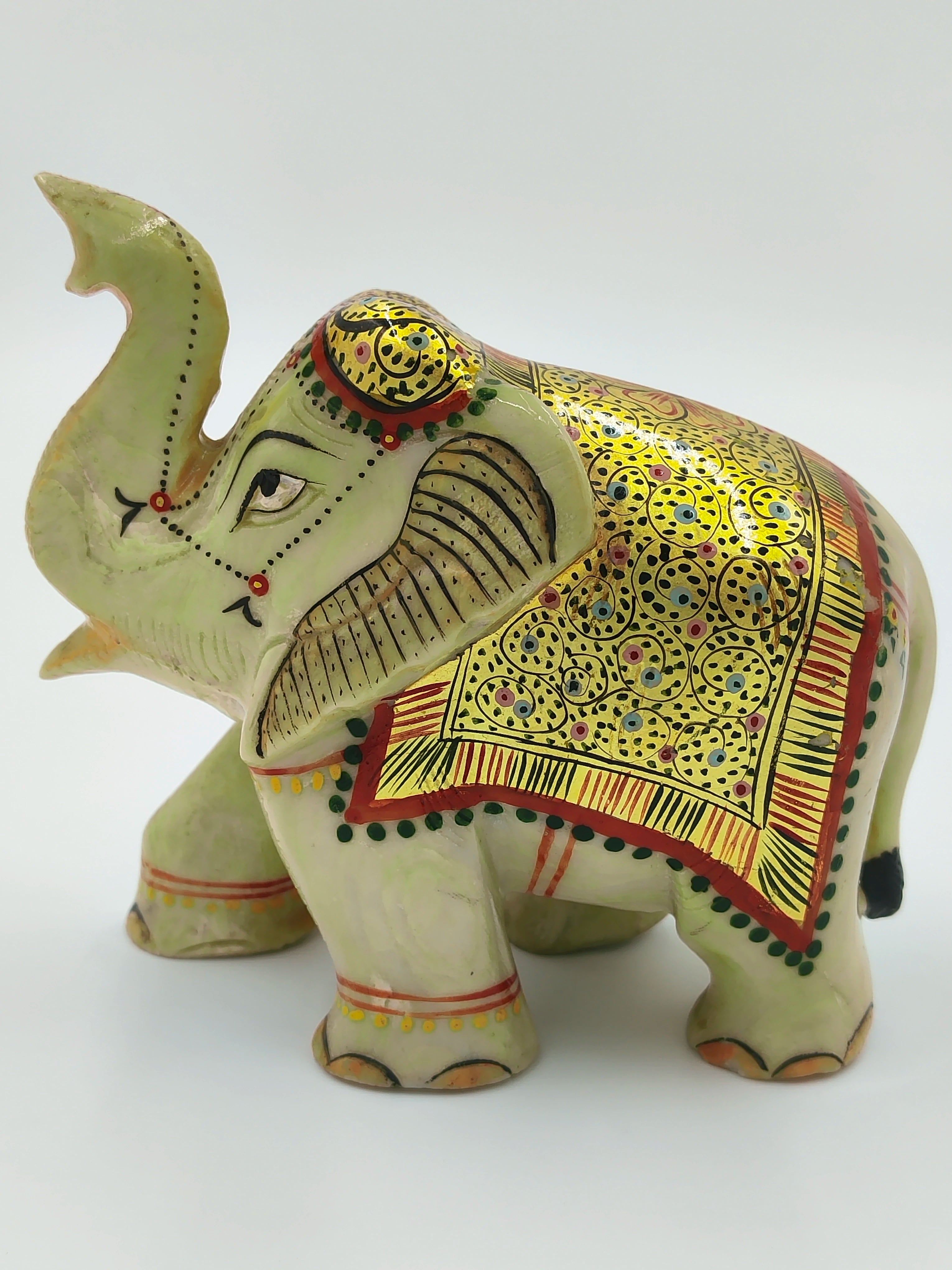Small green serpentine elephant sculpture with detailed painted golden cloth and red accents