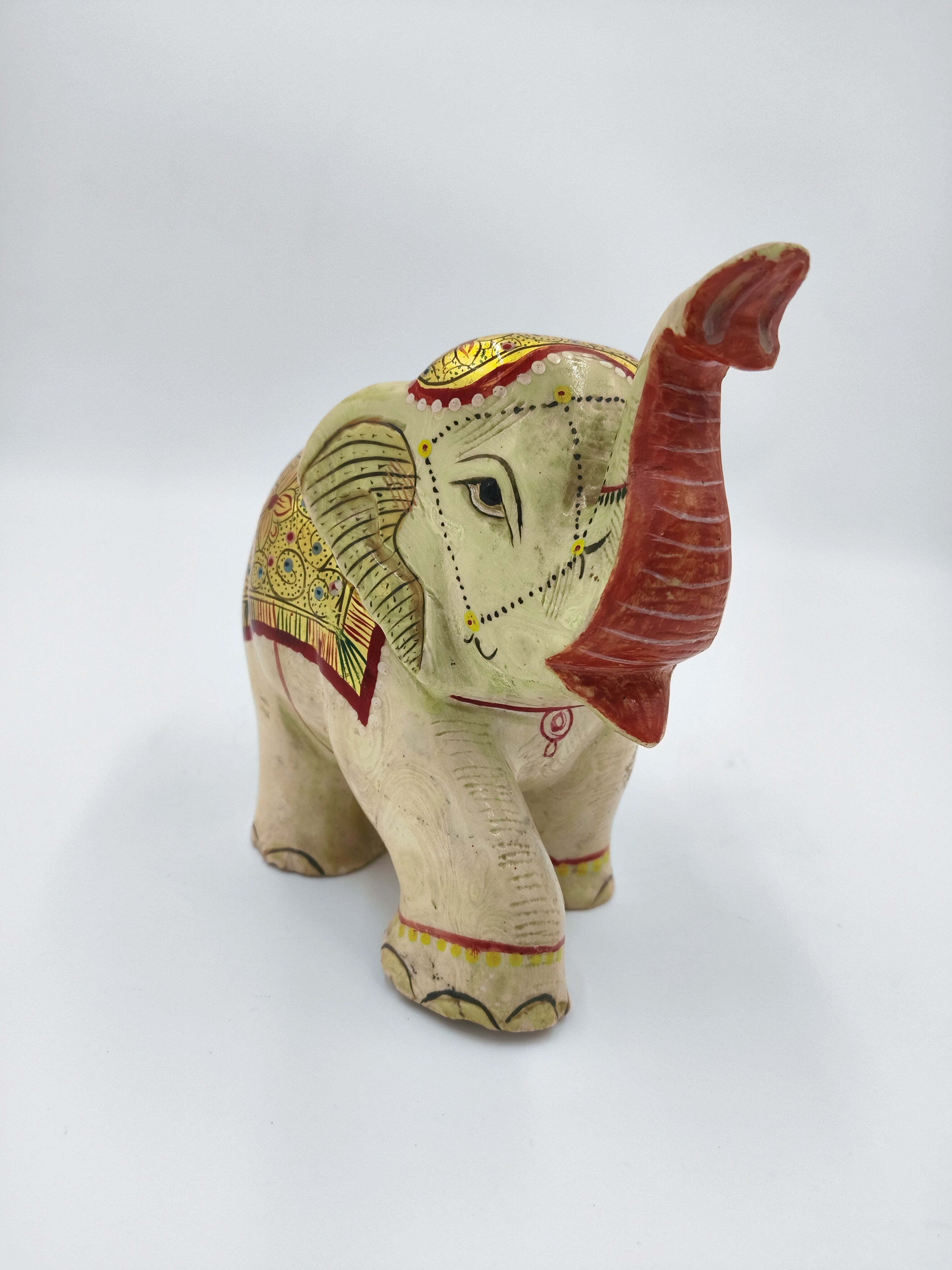 Hand-painted serpentine elephant sculpture with raised trunk and decorative patterns