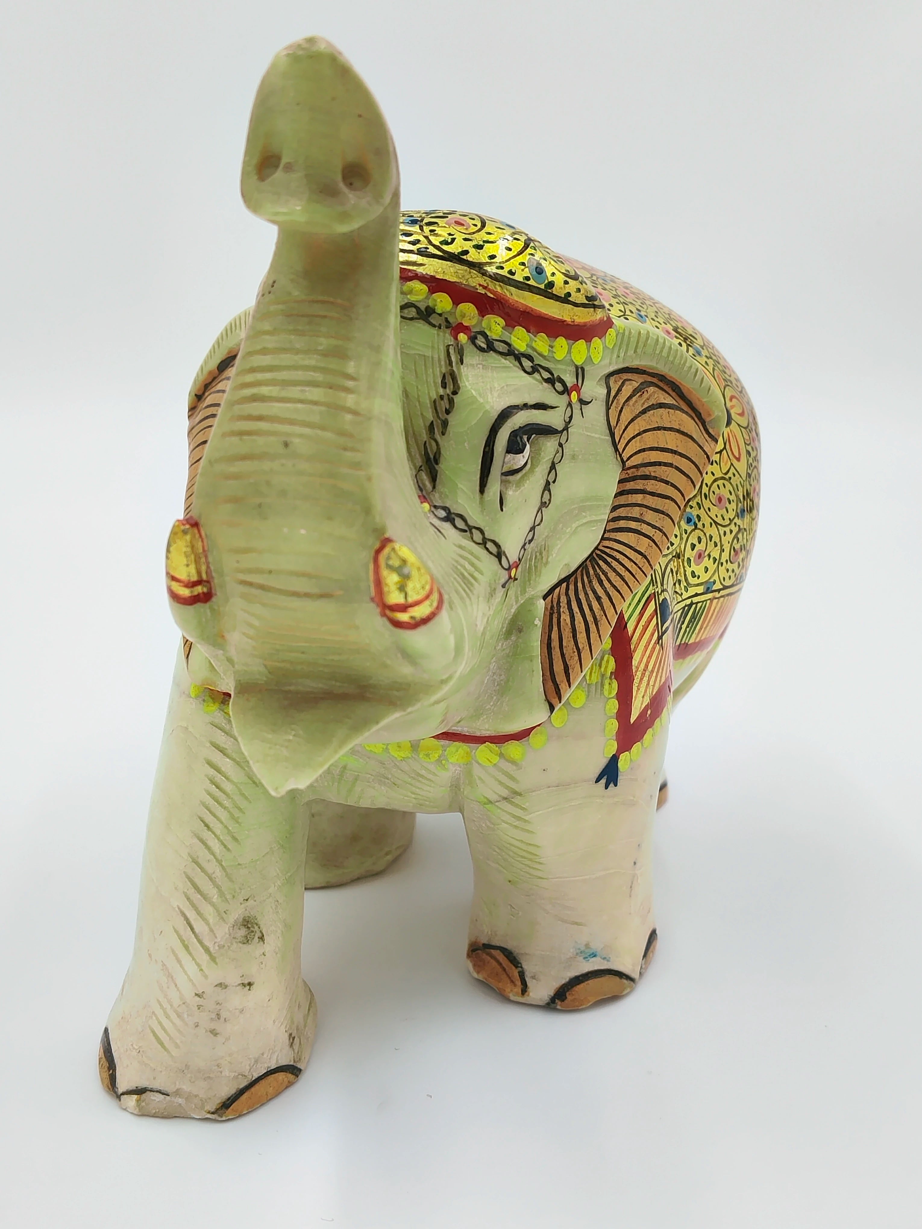 Hand-painted serpentine elephant sculpture with raised trunk and detailed patterns