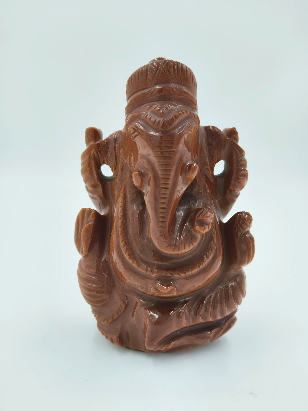 Front view of a carved Sunstone Ganesh idol sculpture