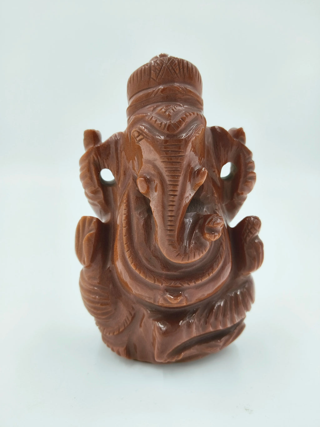 Front view of medium-sized sunstone Ganesh statue with detailed carvings