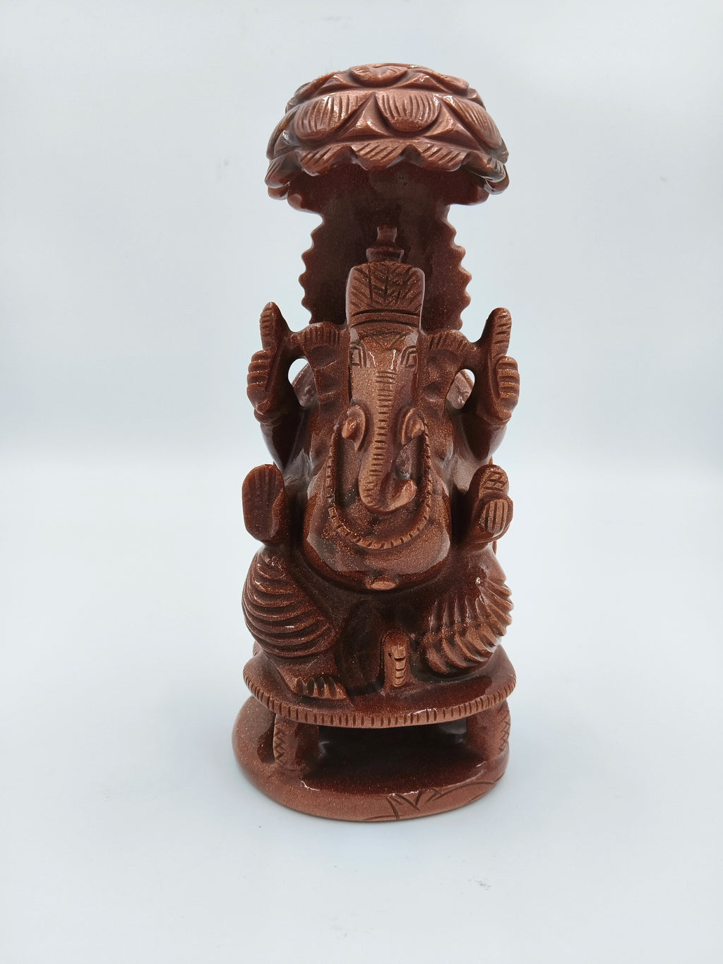 Front view of 7-inch Sunstone Ganesh statue with umbrella