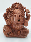 Front view of a sunstone Ganesh sculpture with intricate detailing
