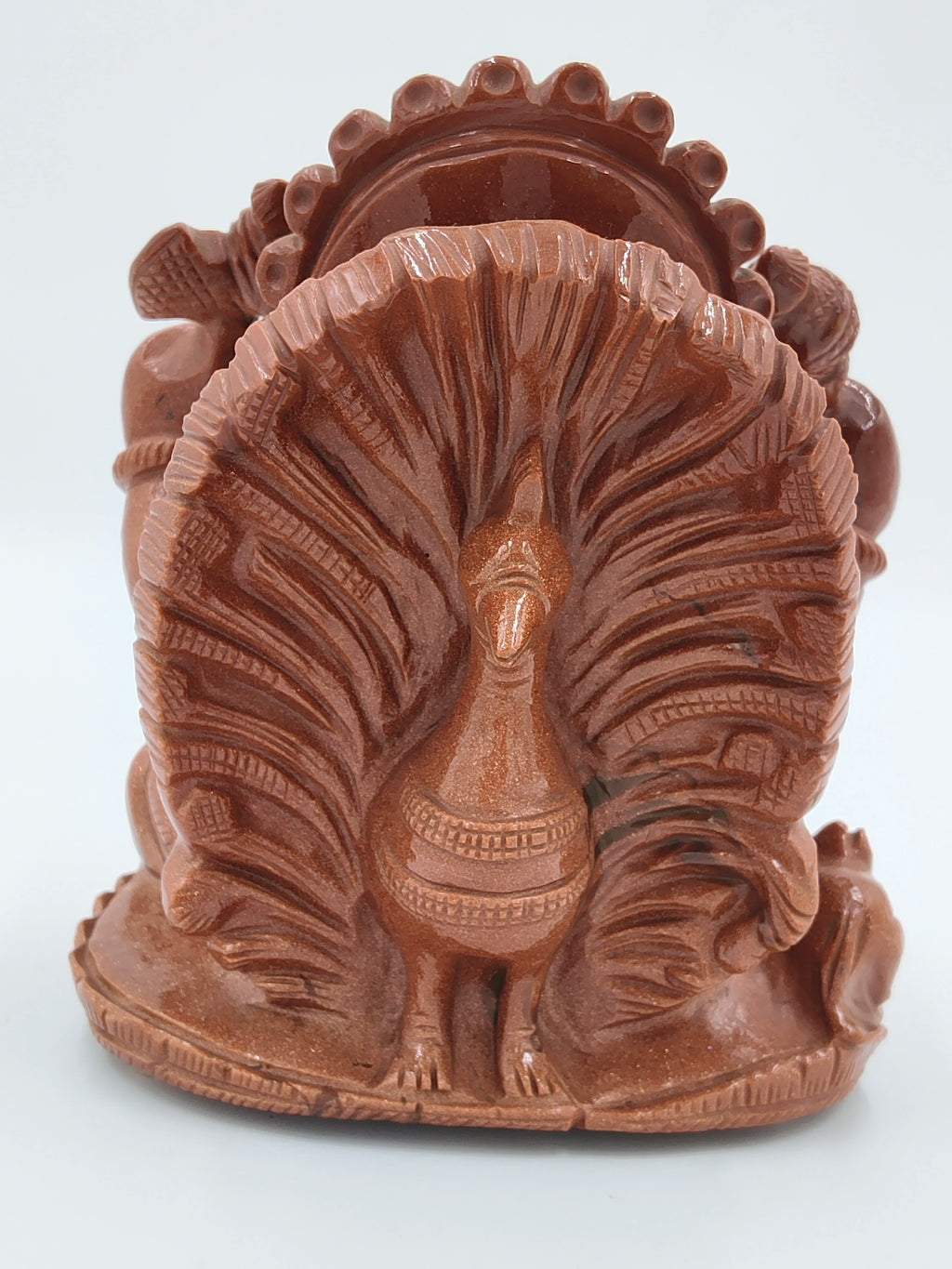 Back view of a detailed Sunstone Ganesh sculpture with peacock motif