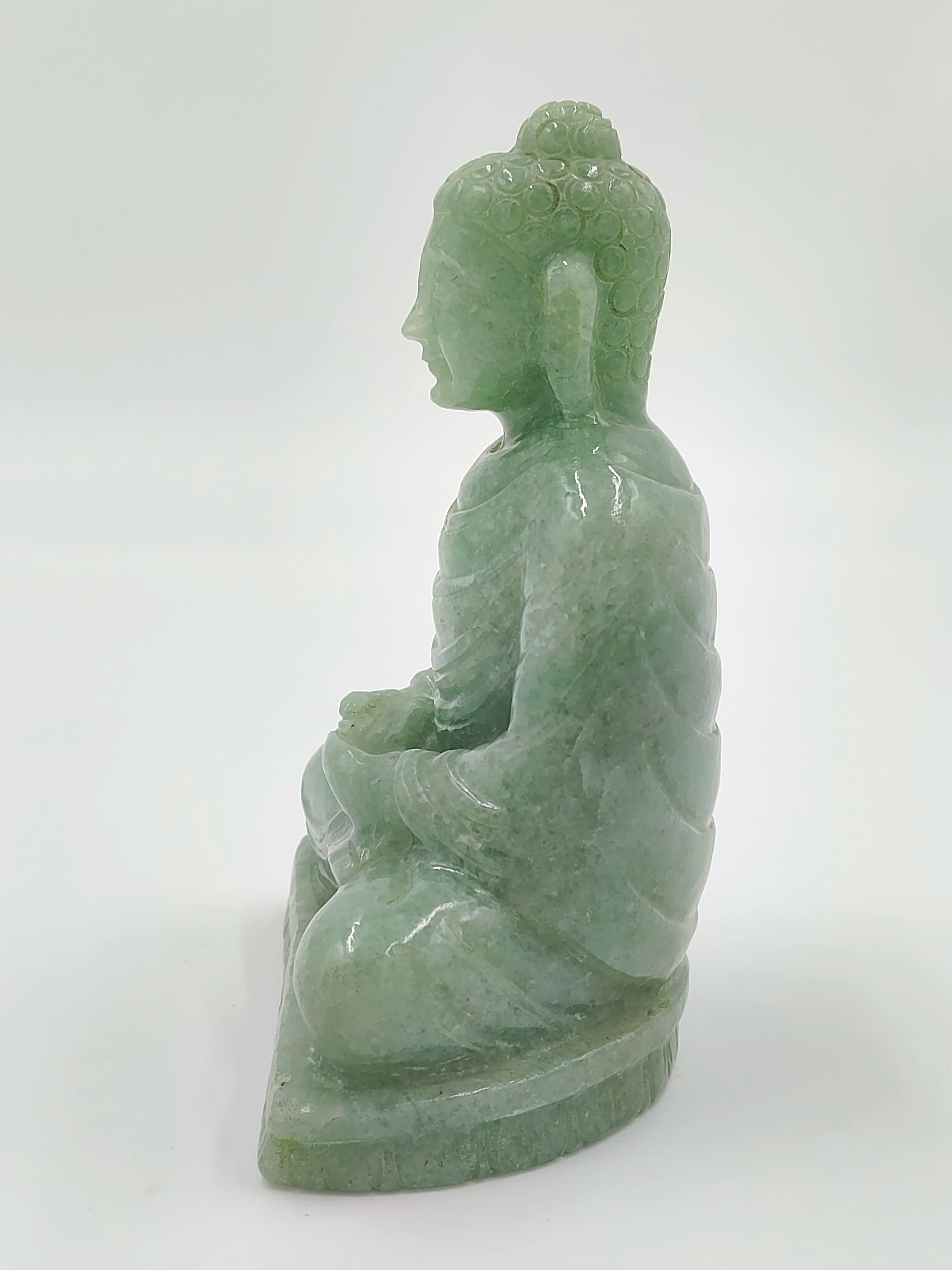 Side view of a 4.3 inch jade Buddha sculpture in seated meditation pose
