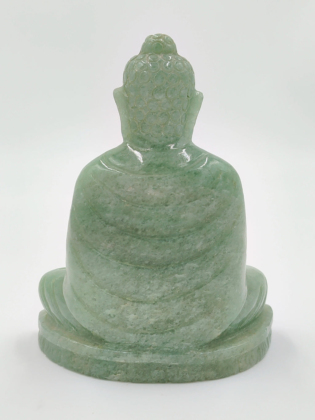 Back view of a 4.3-inch jade Buddha sculpture sitting on a base