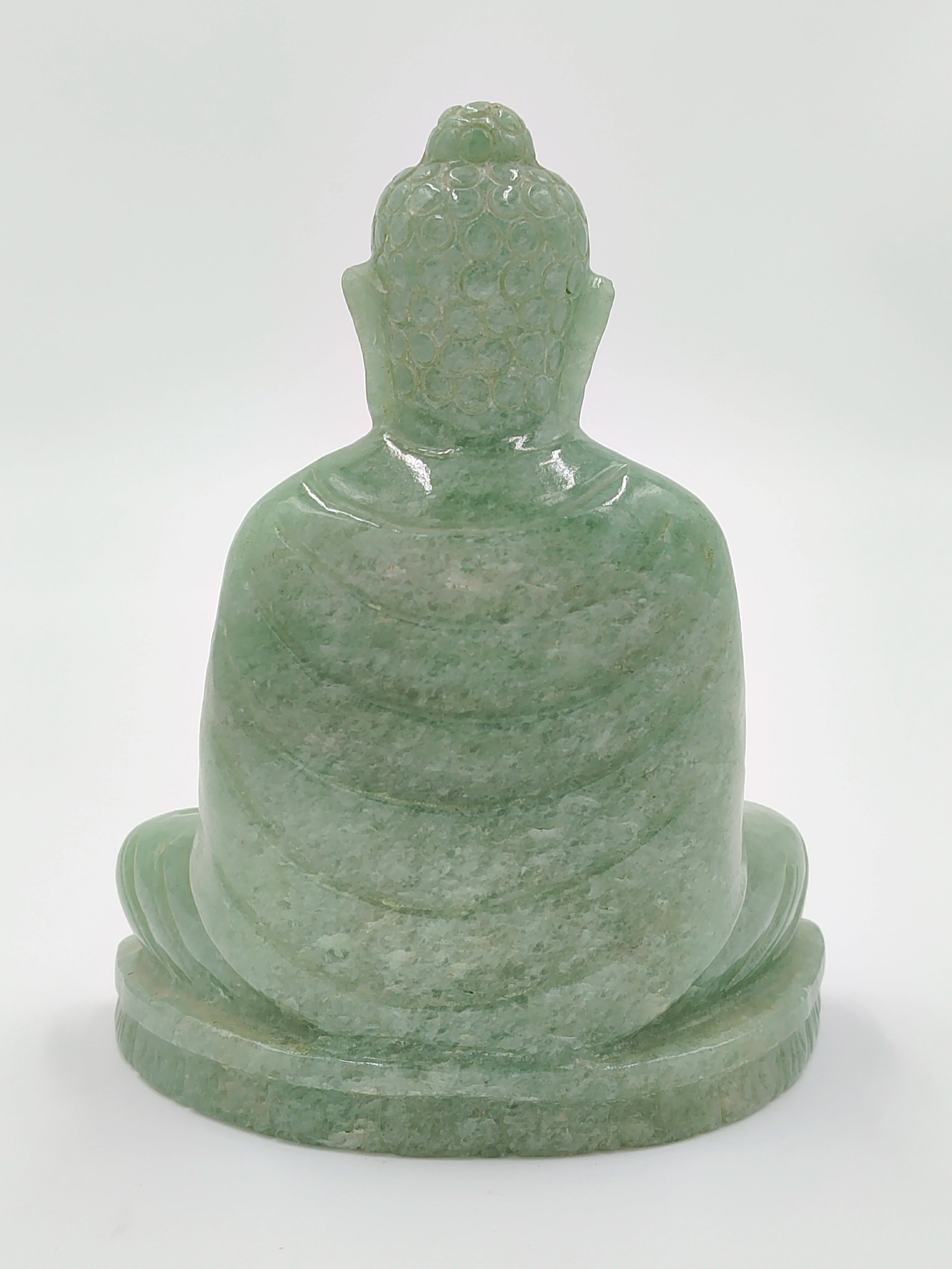 Back view of a 4.3-inch jade Buddha sculpture sitting on a base