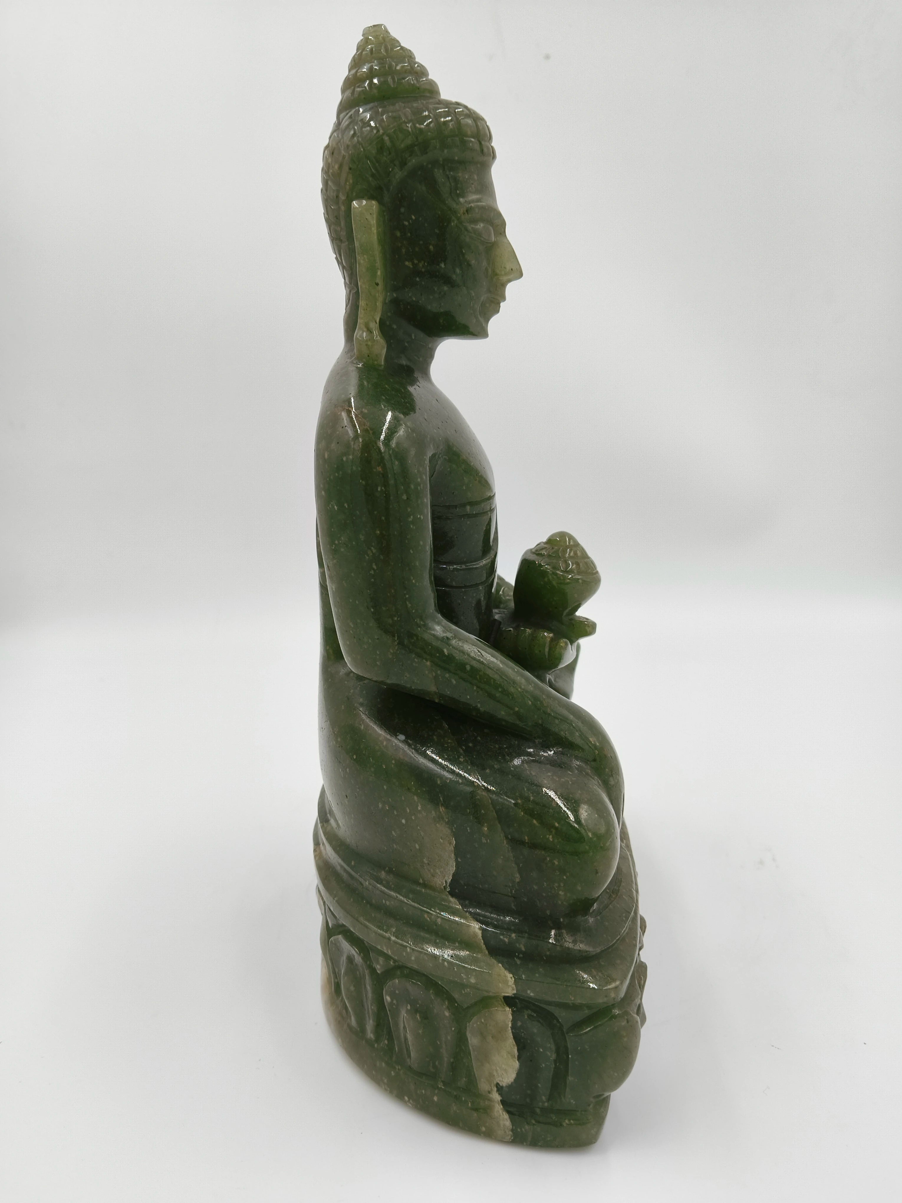 Side view of 9 inch large green jade Buddha sculpture seated on detailed base