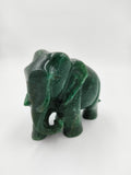 Small green jade elephant sculpture with carved details side view