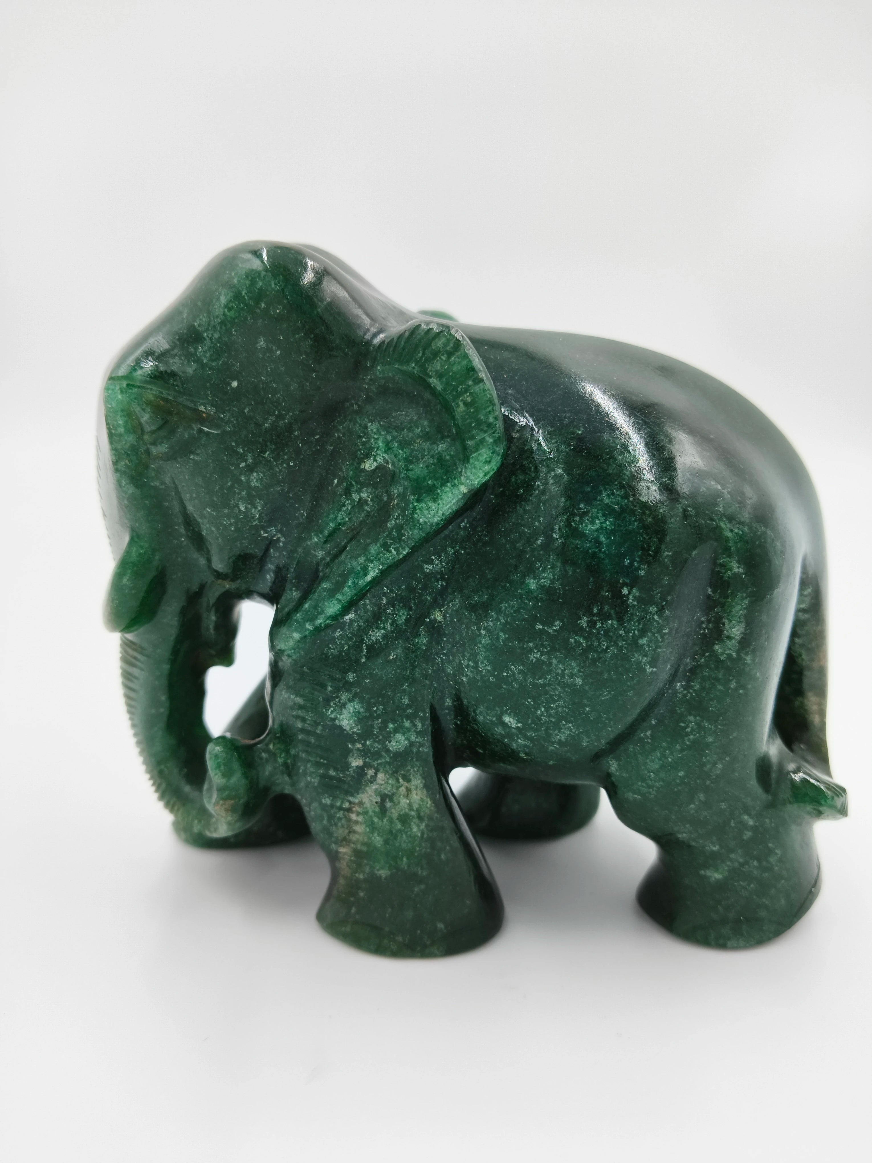 Small green jade elephant figurine sculpture facing left