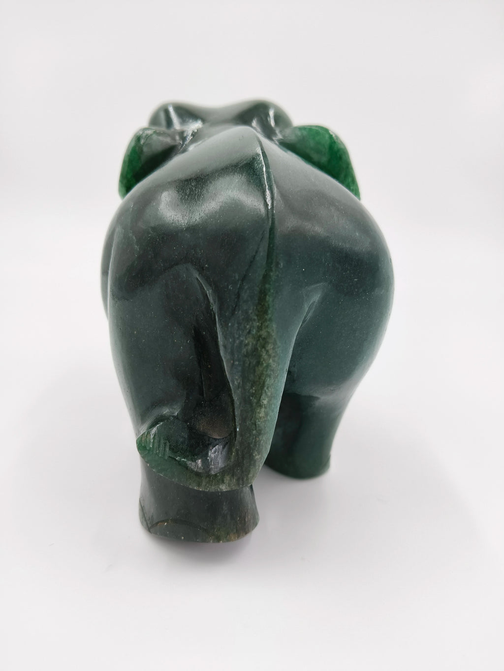 Rear view of small green jade elephant sculpture