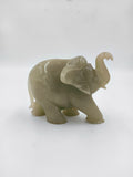 Small jade elephant figurine with raised trunk, side view