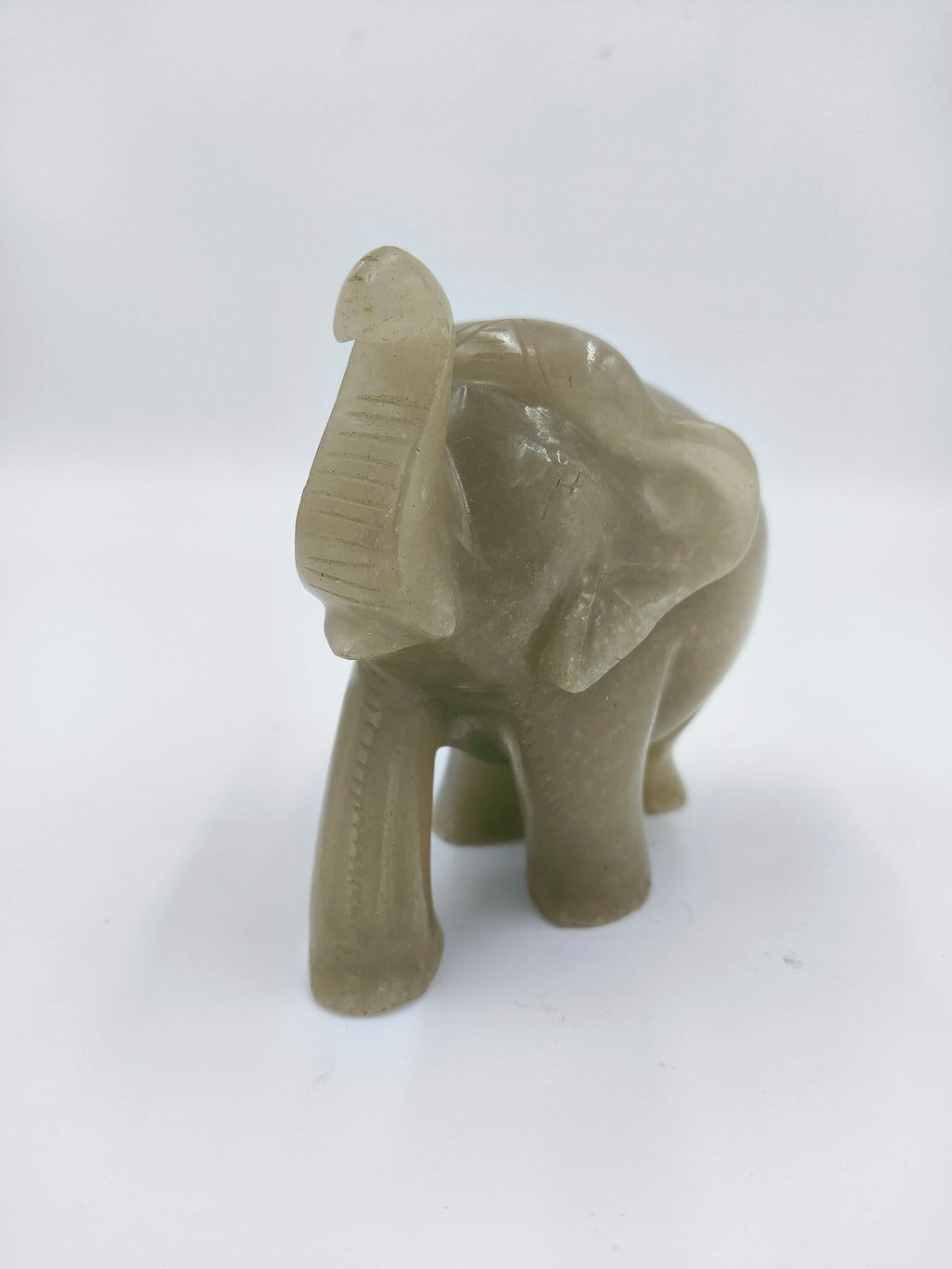 Small jade elephant figurine with raised trunk and carved details