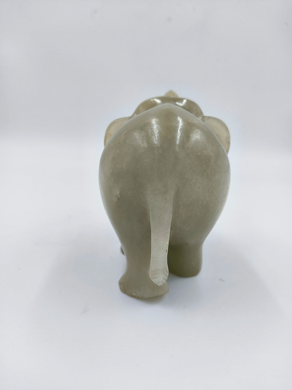 Back view of small jade elephant figurine sculpture