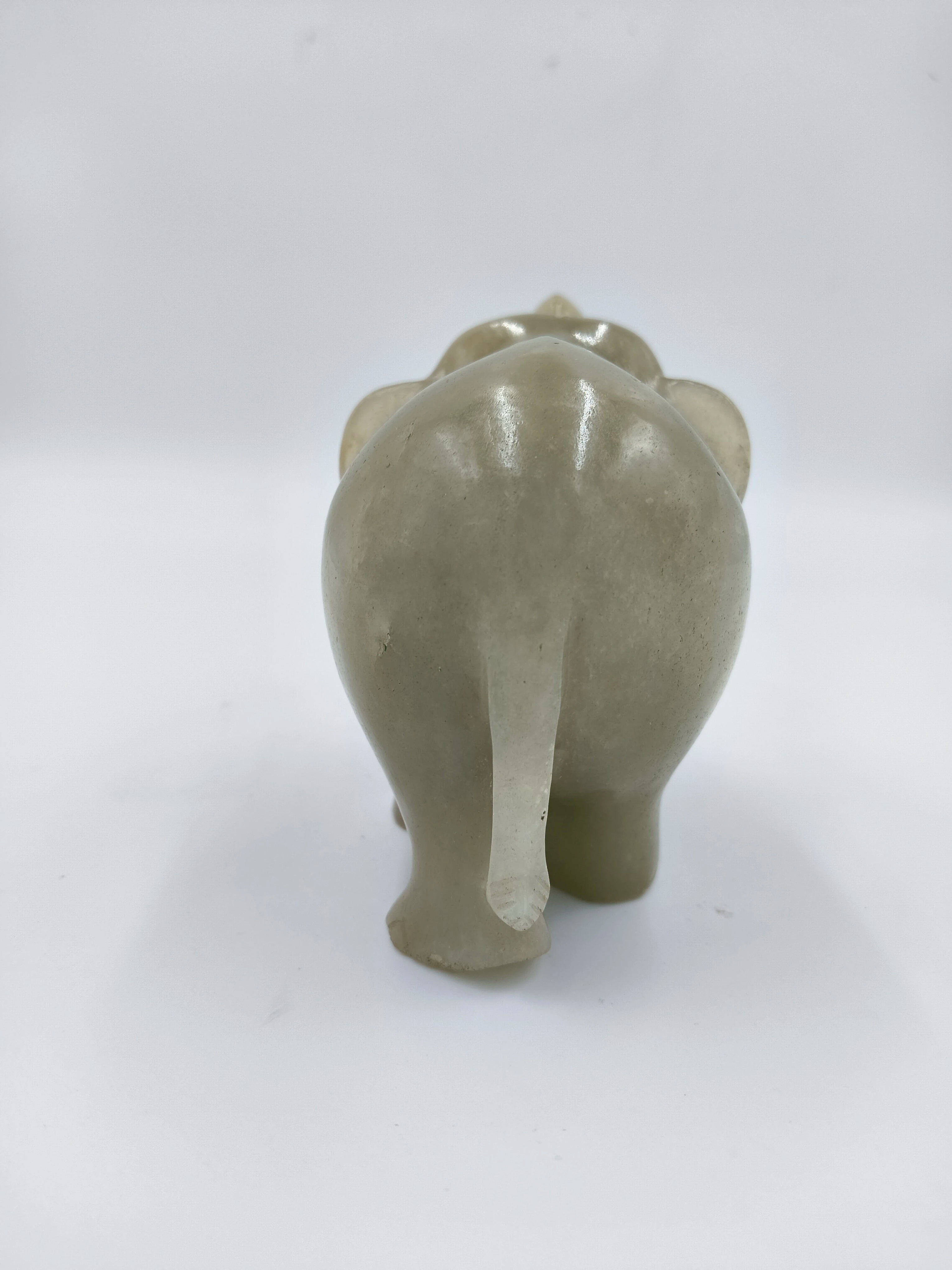 Back view of small jade elephant figurine sculpture