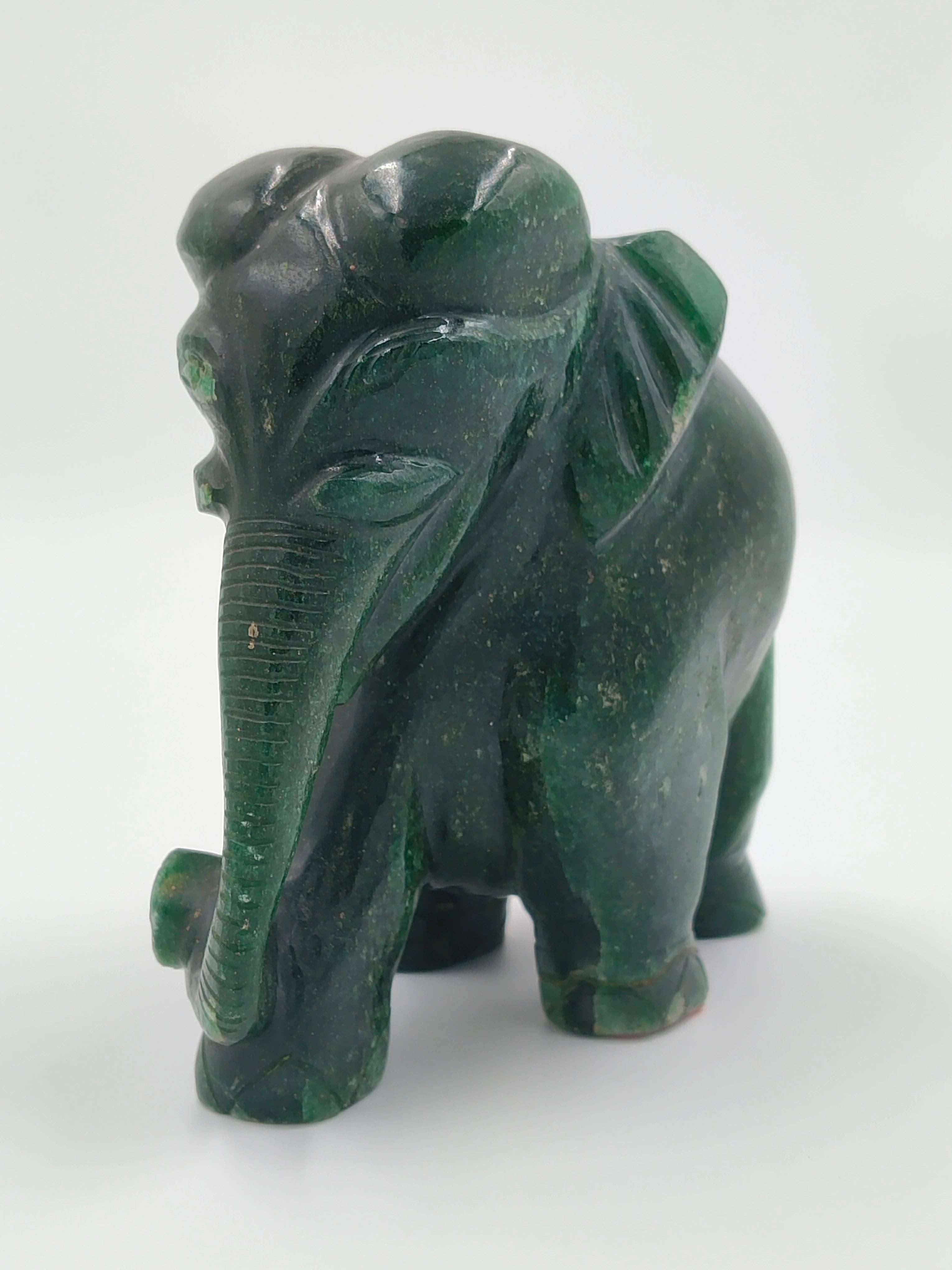 Front view of a small dark green jade elephant sculpture