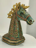 Large jade horse head sculpture with gold accents and colorful floral paintings