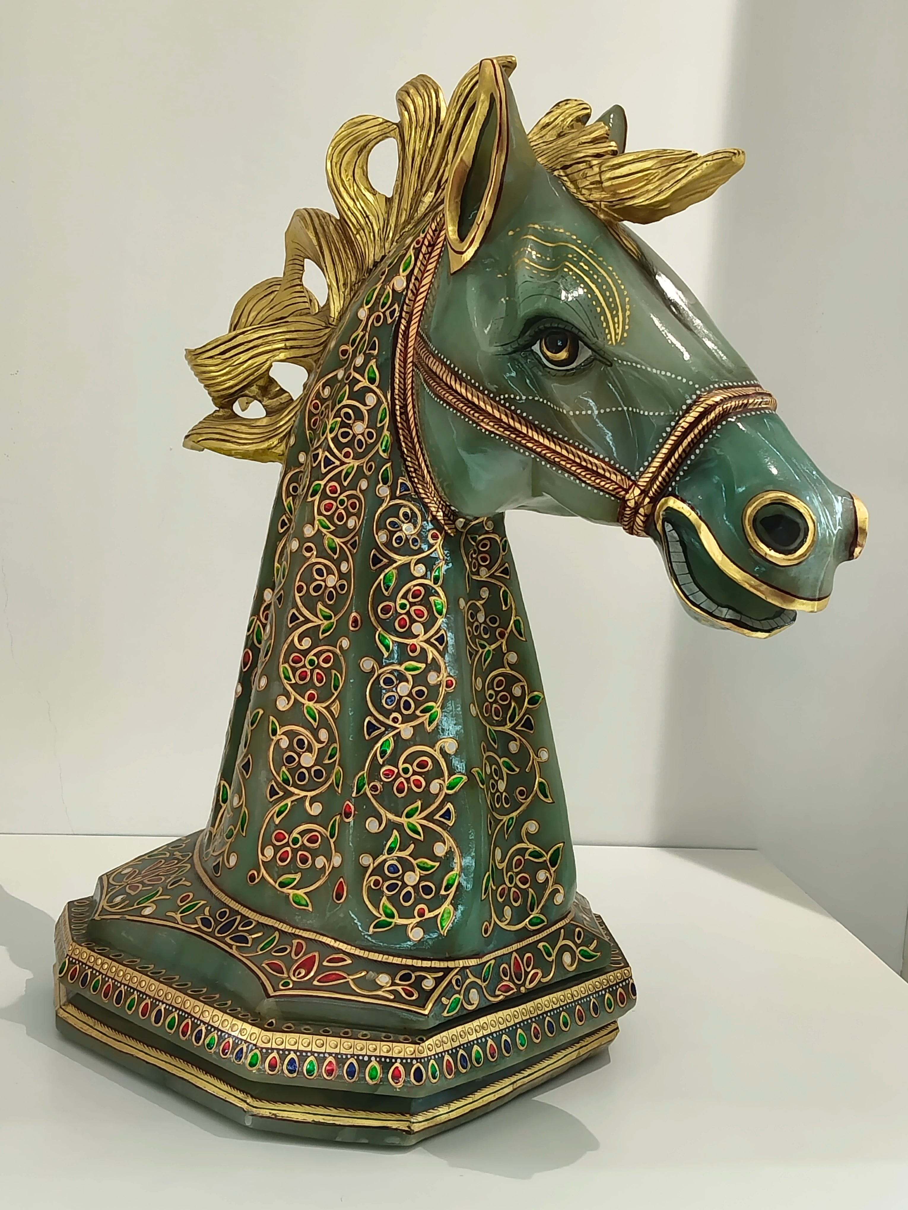 Large jade horse head sculpture with gold accents and colorful floral paintings