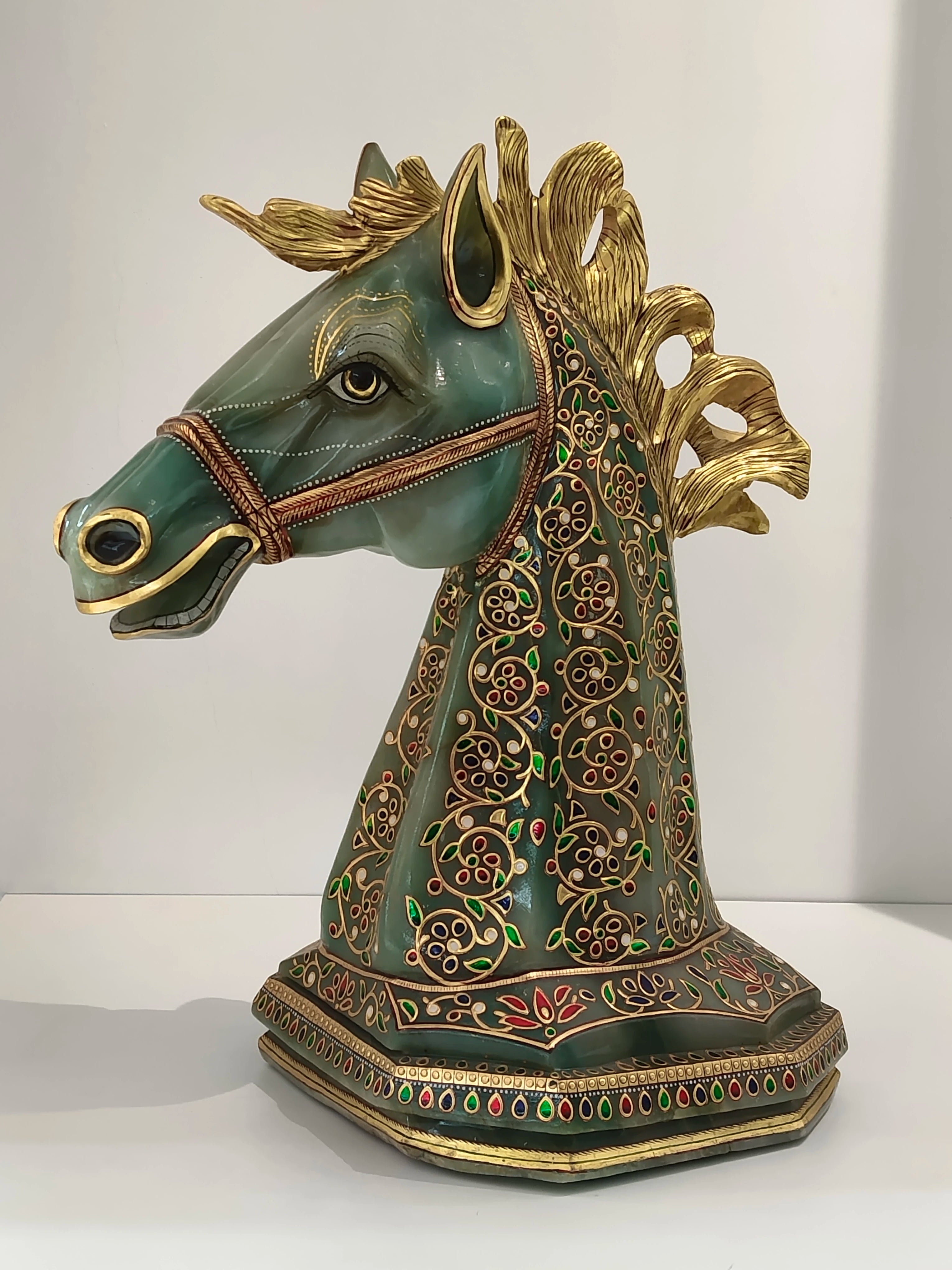 Large jade horse head sculpture with gold accents and multicolored floral patterns