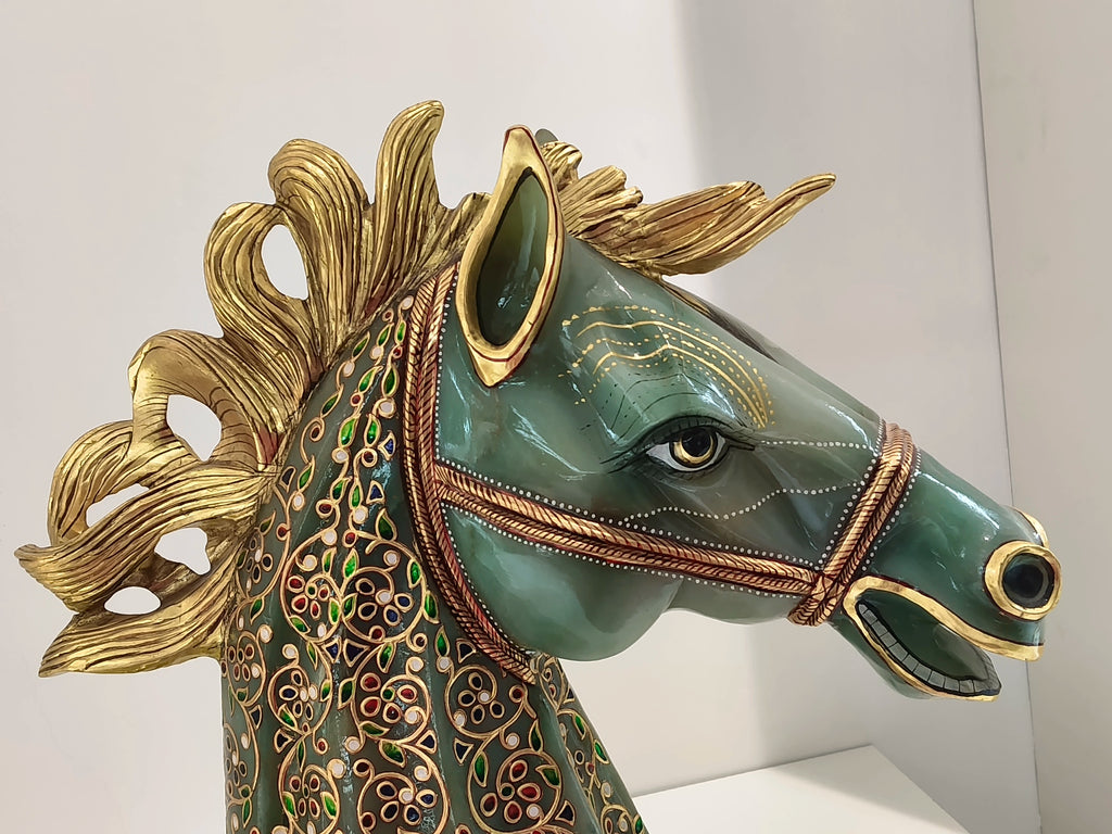 Large jade horse head sculpture with gold accents and detailed multicolored floral paintings