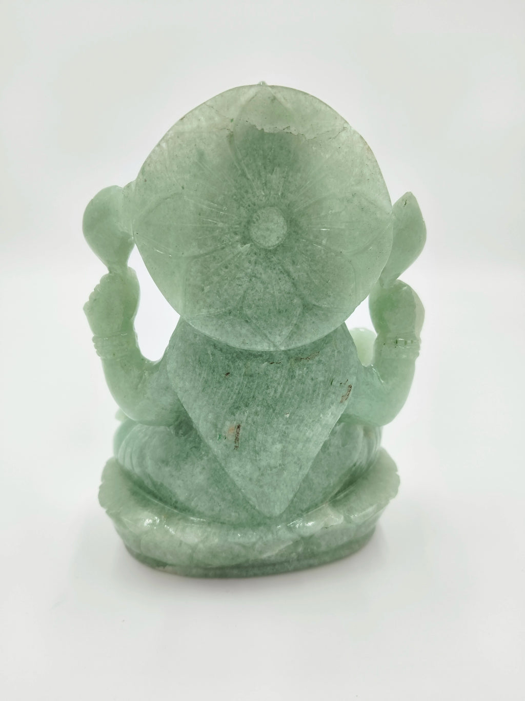 Back view of a jade Lakshmi statue with carved lotus on head
