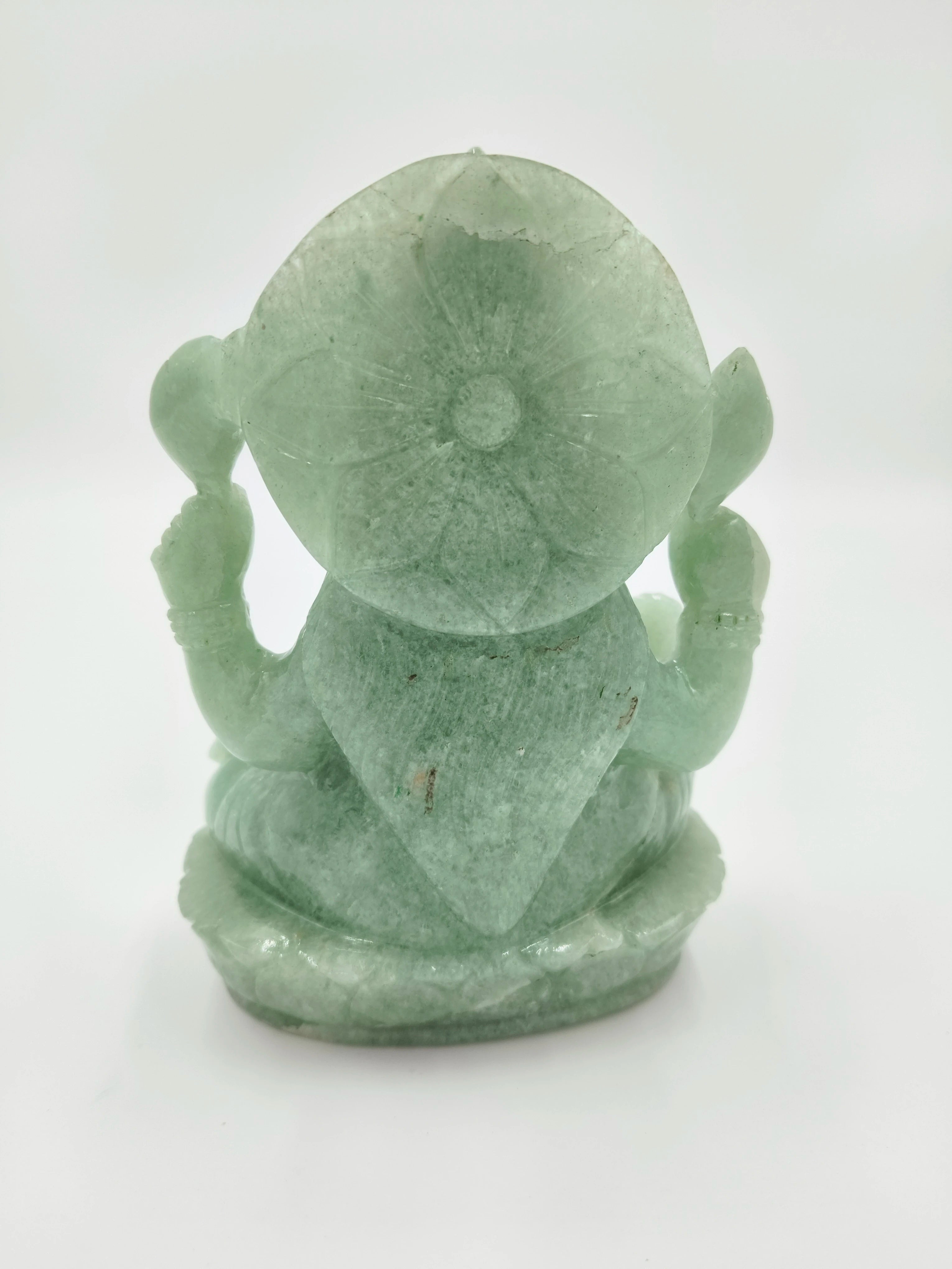 Back view of a jade Lakshmi statue with carved lotus on head